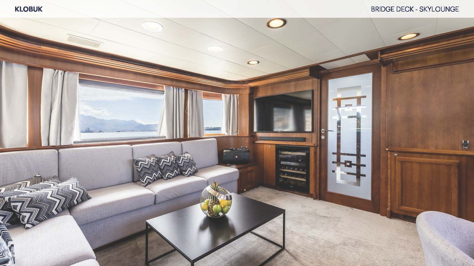 a living room with a couch and a coffee table aboard KLOBUK Yacht for Charter