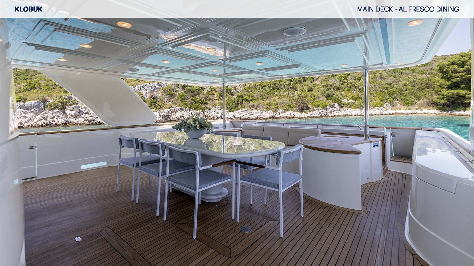 a table and chairs on a deck aboard KLOBUK Yacht for Charter