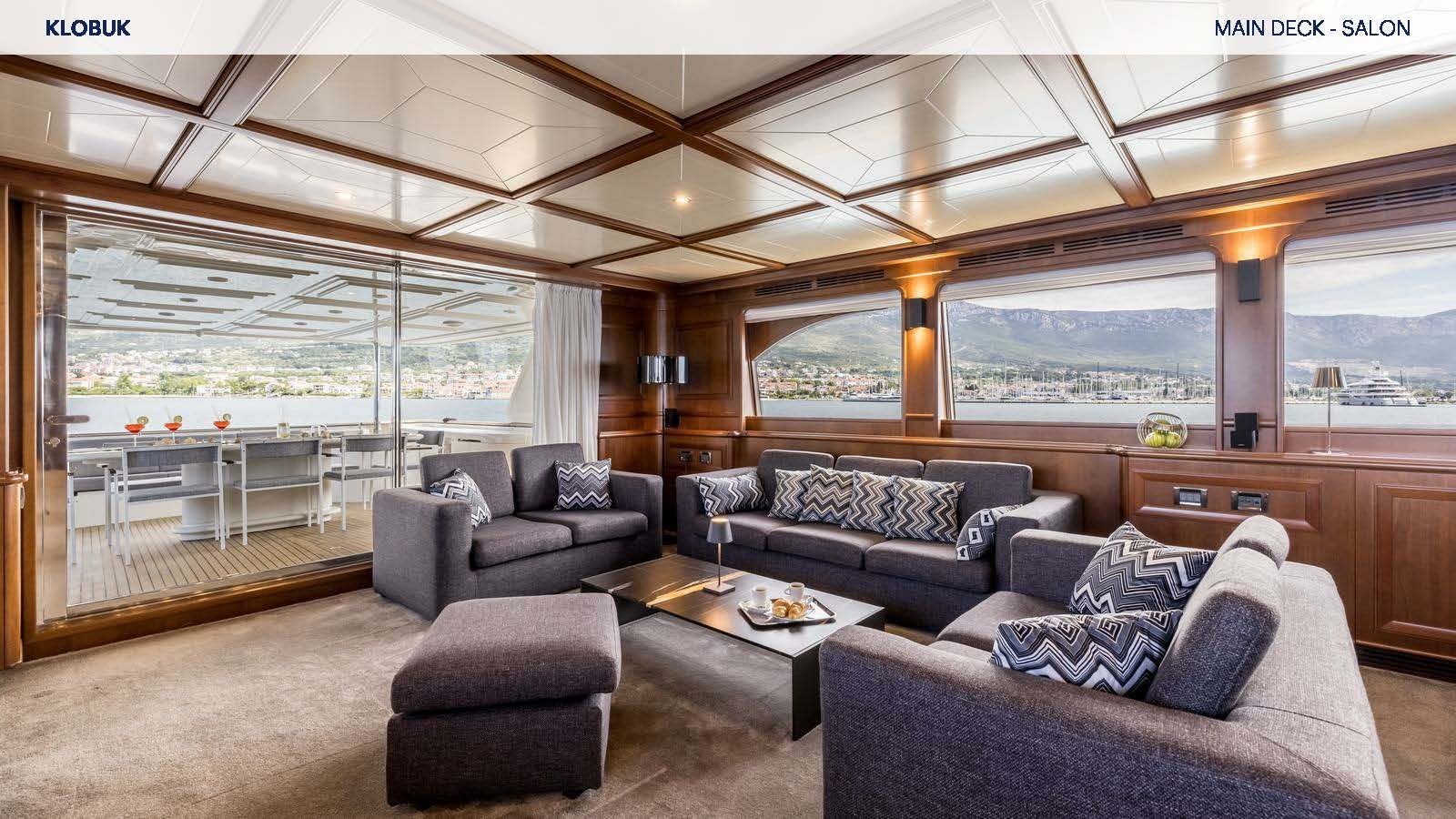a living room with a large window aboard KLOBUK Yacht for Charter