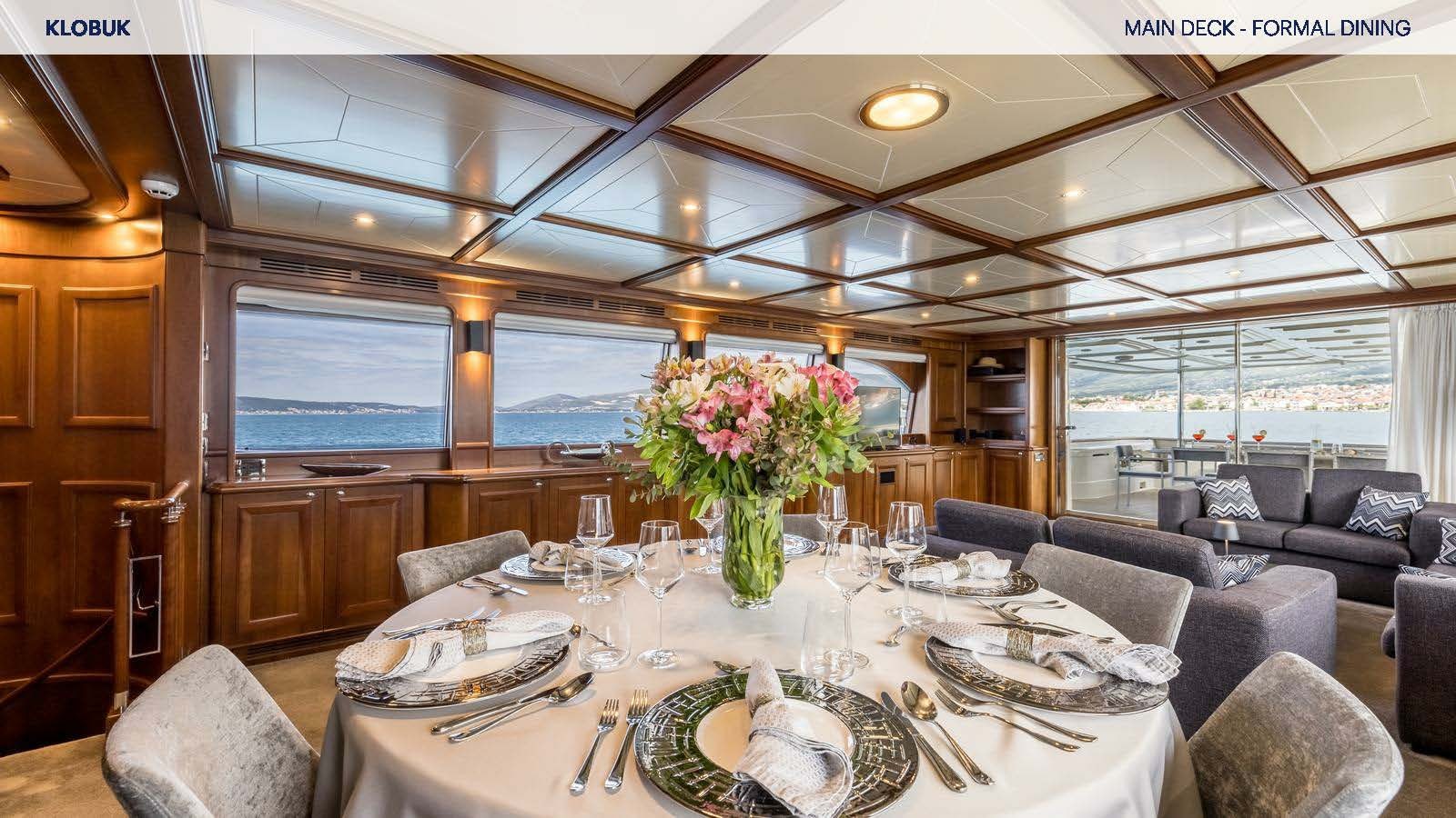 a dining room with a large window aboard KLOBUK Yacht for Charter