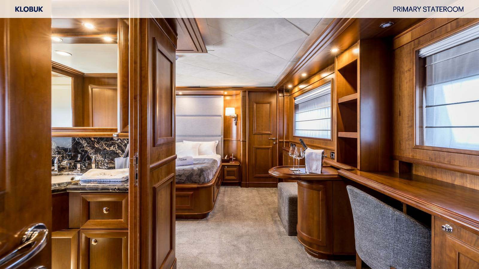 a room with a bed and desk aboard KLOBUK Yacht for Charter