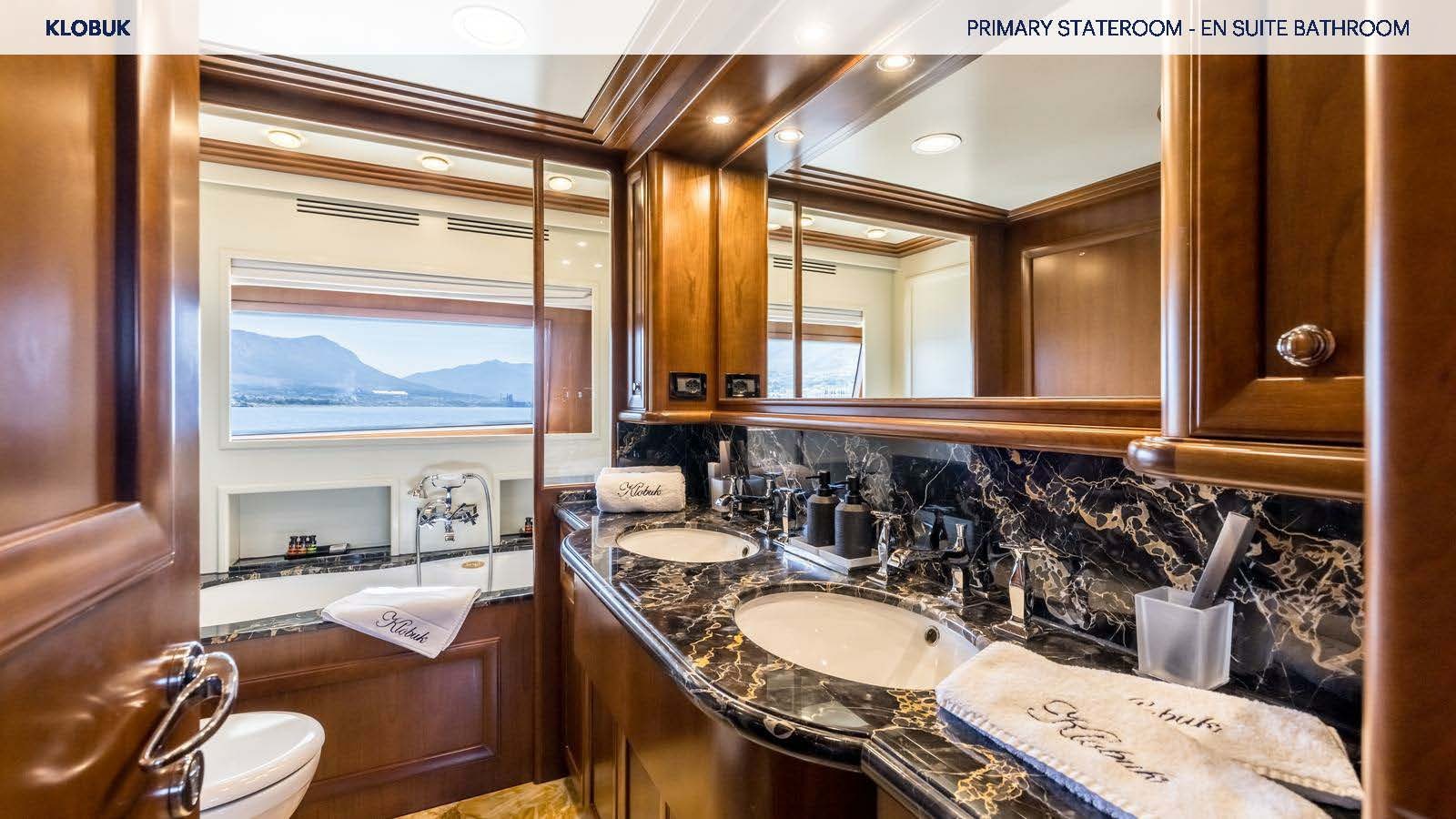 a bathroom with a countertop sink and a mirror aboard KLOBUK Yacht for Charter