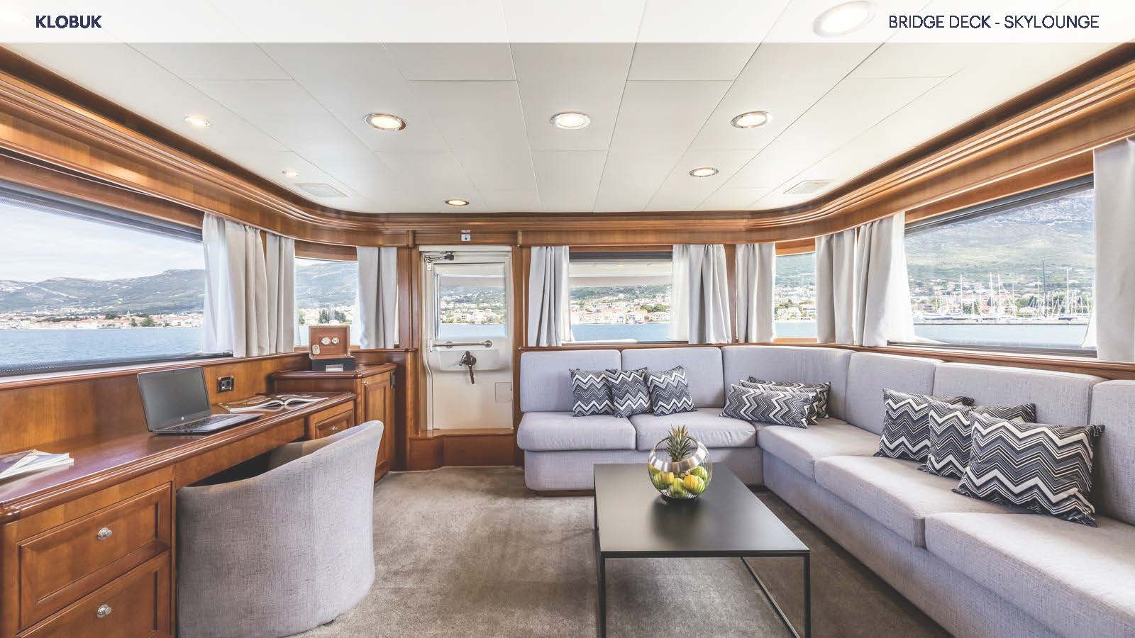 a living room with a couch and a table aboard KLOBUK Yacht for Charter
