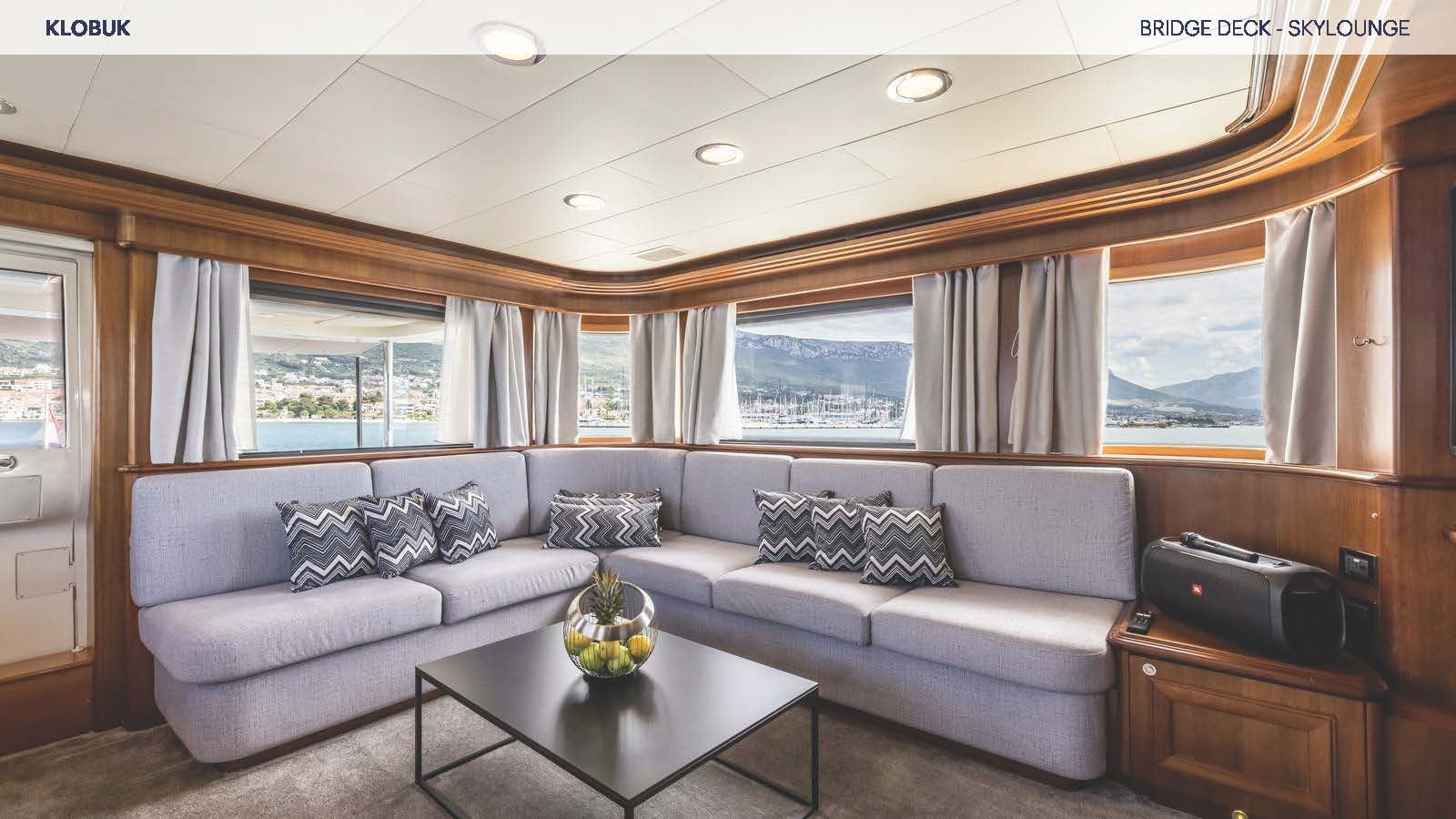 a living room with a couch and a coffee table aboard KLOBUK Yacht for Charter