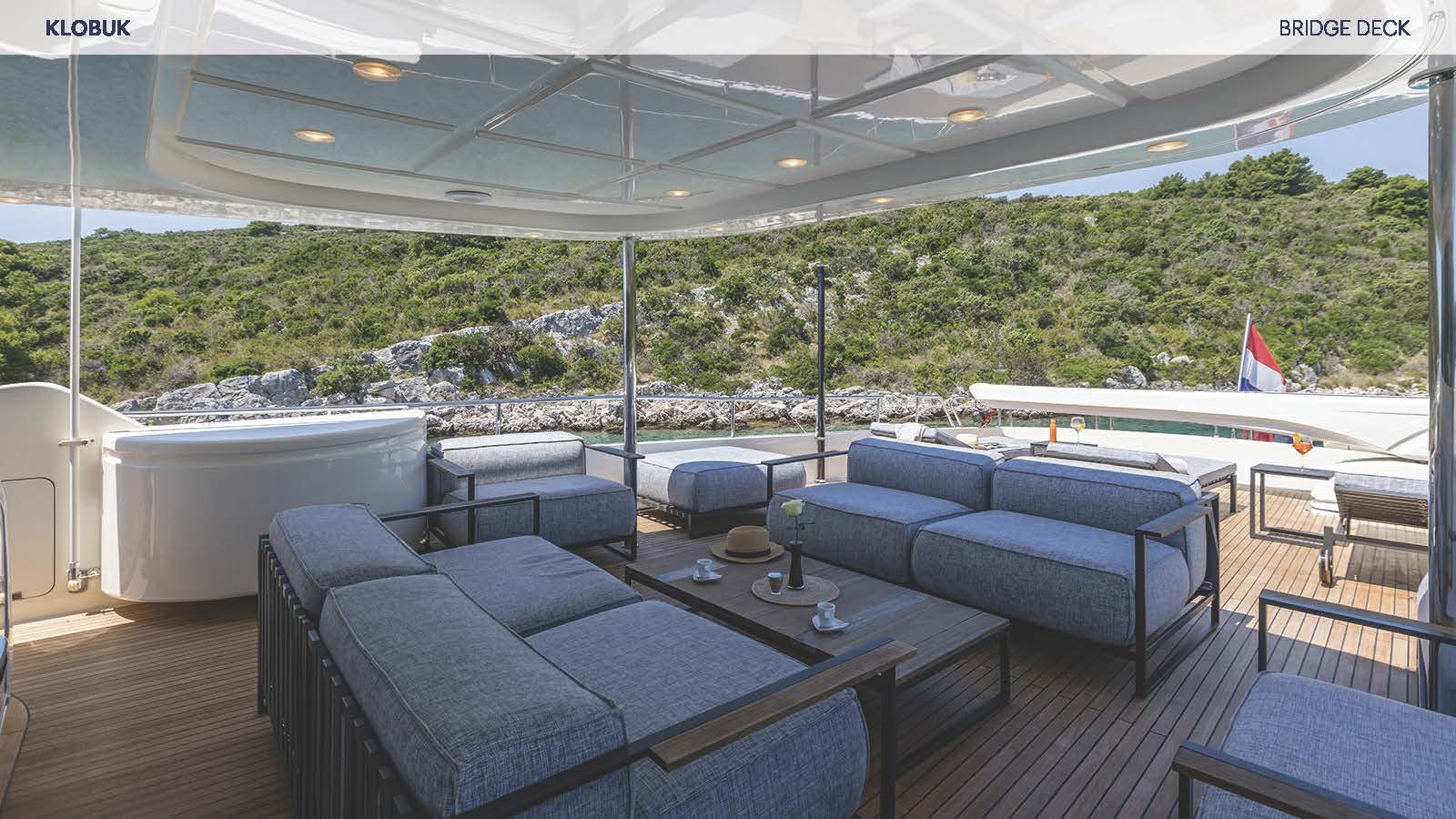 a large room with couches and a pool aboard KLOBUK Yacht for Charter