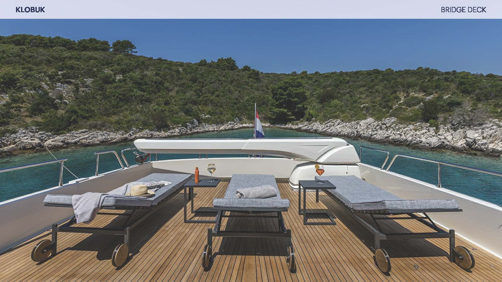 a deck with a pool and a plane on it aboard KLOBUK Yacht for Charter