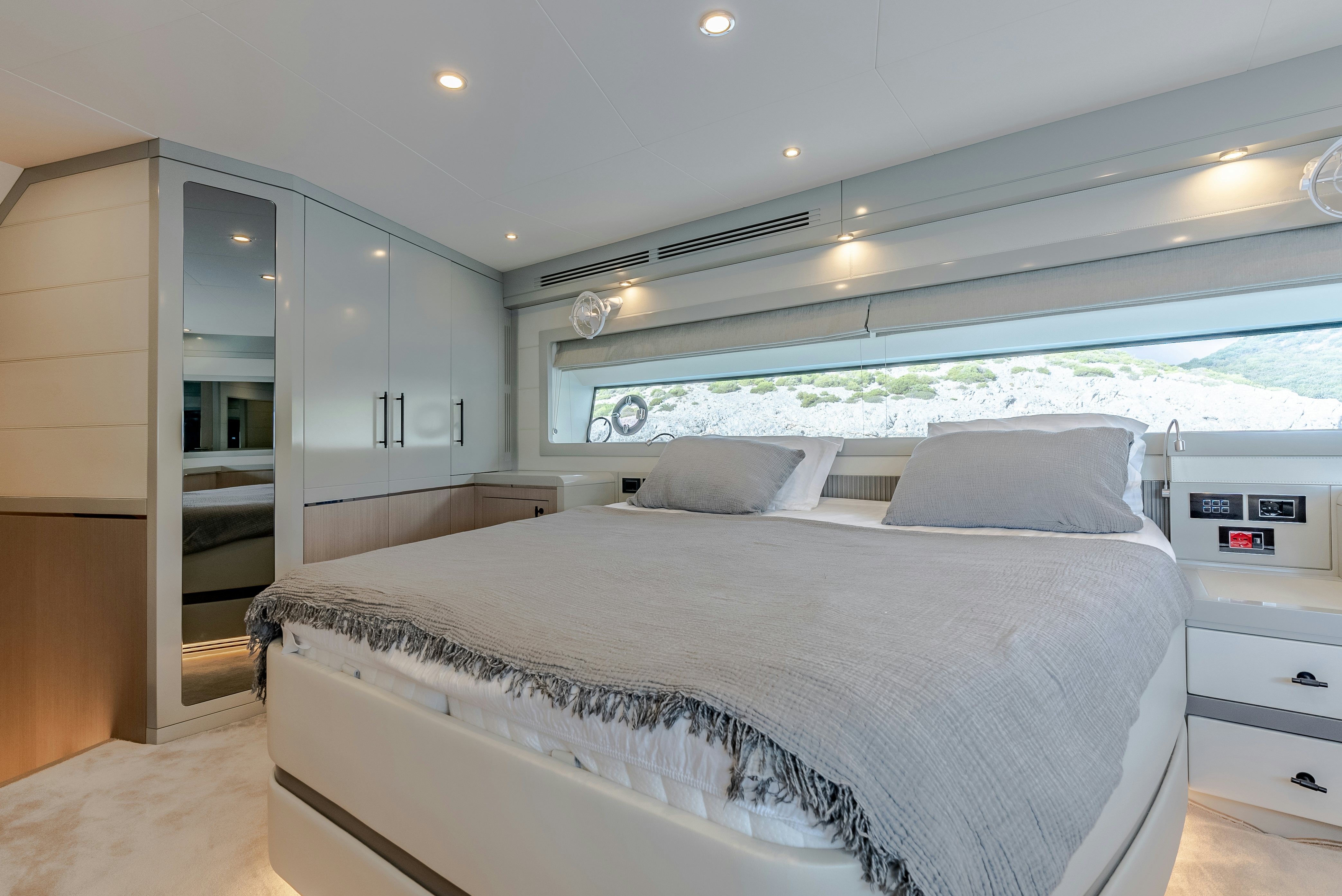 a large white bedroom with a large bed and a large window aboard GALENE IV Yacht for Sale
