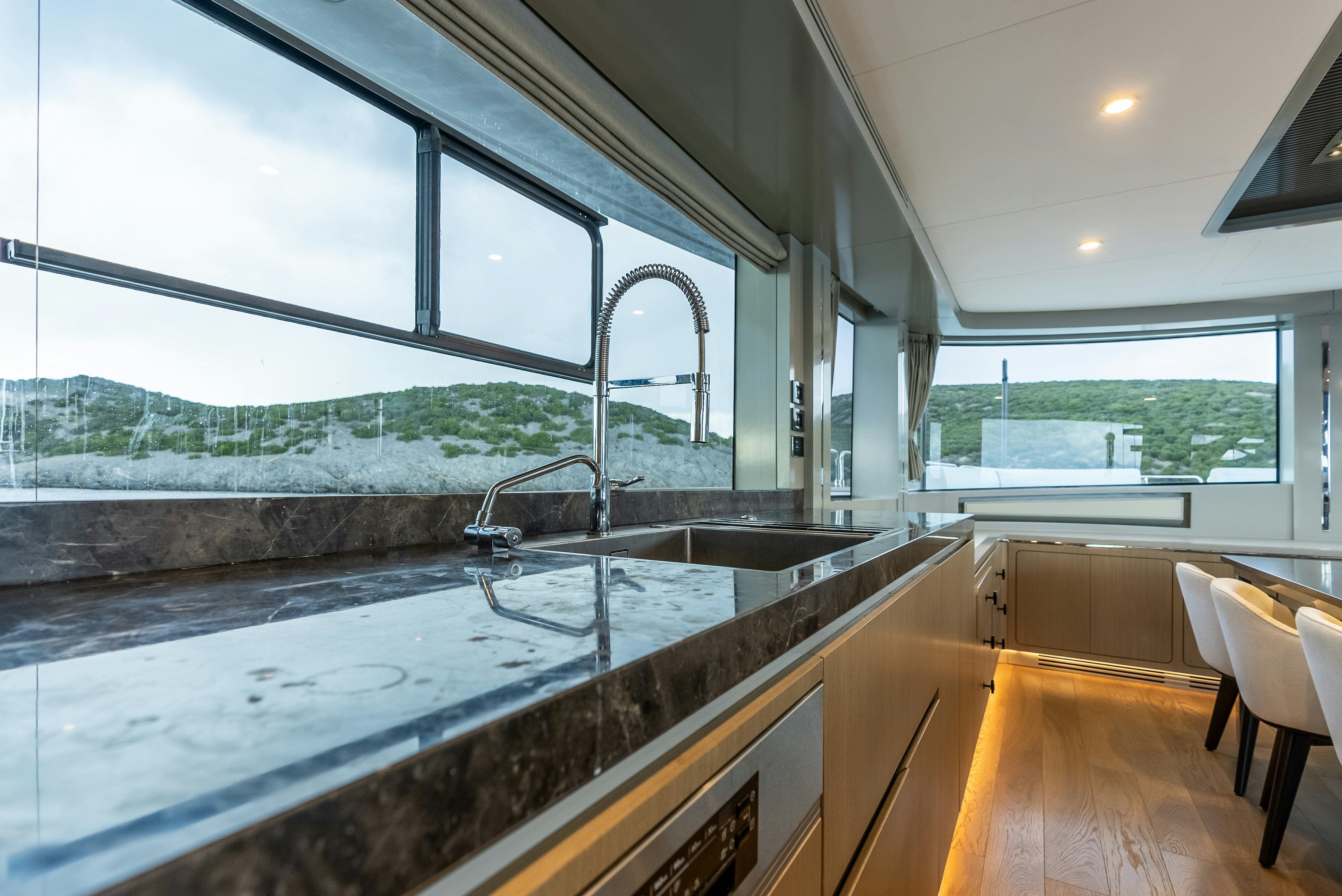 a kitchen with a large window aboard GALENE IV Yacht for Sale