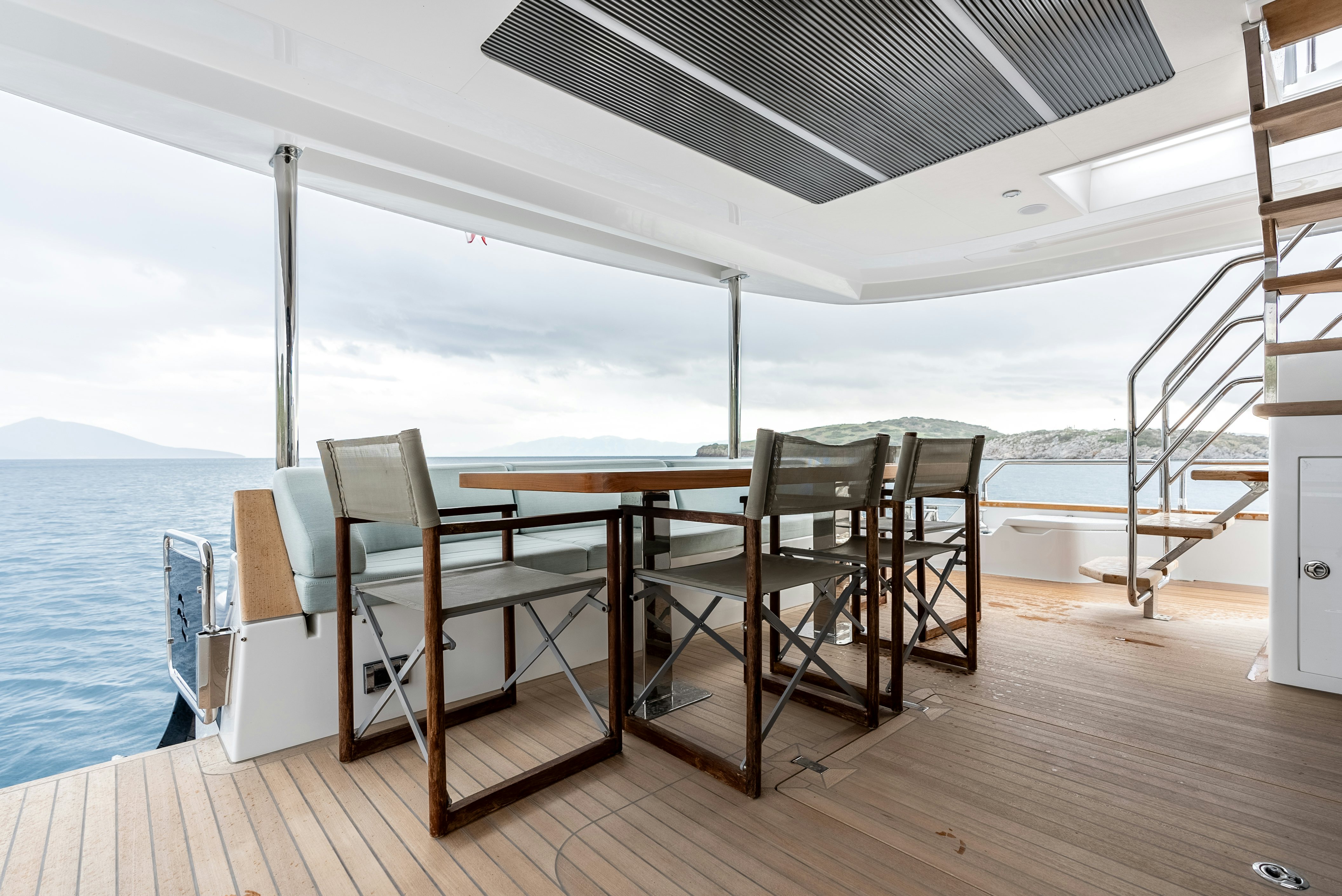 a deck with chairs and a table on it aboard GALENE IV Yacht for Sale