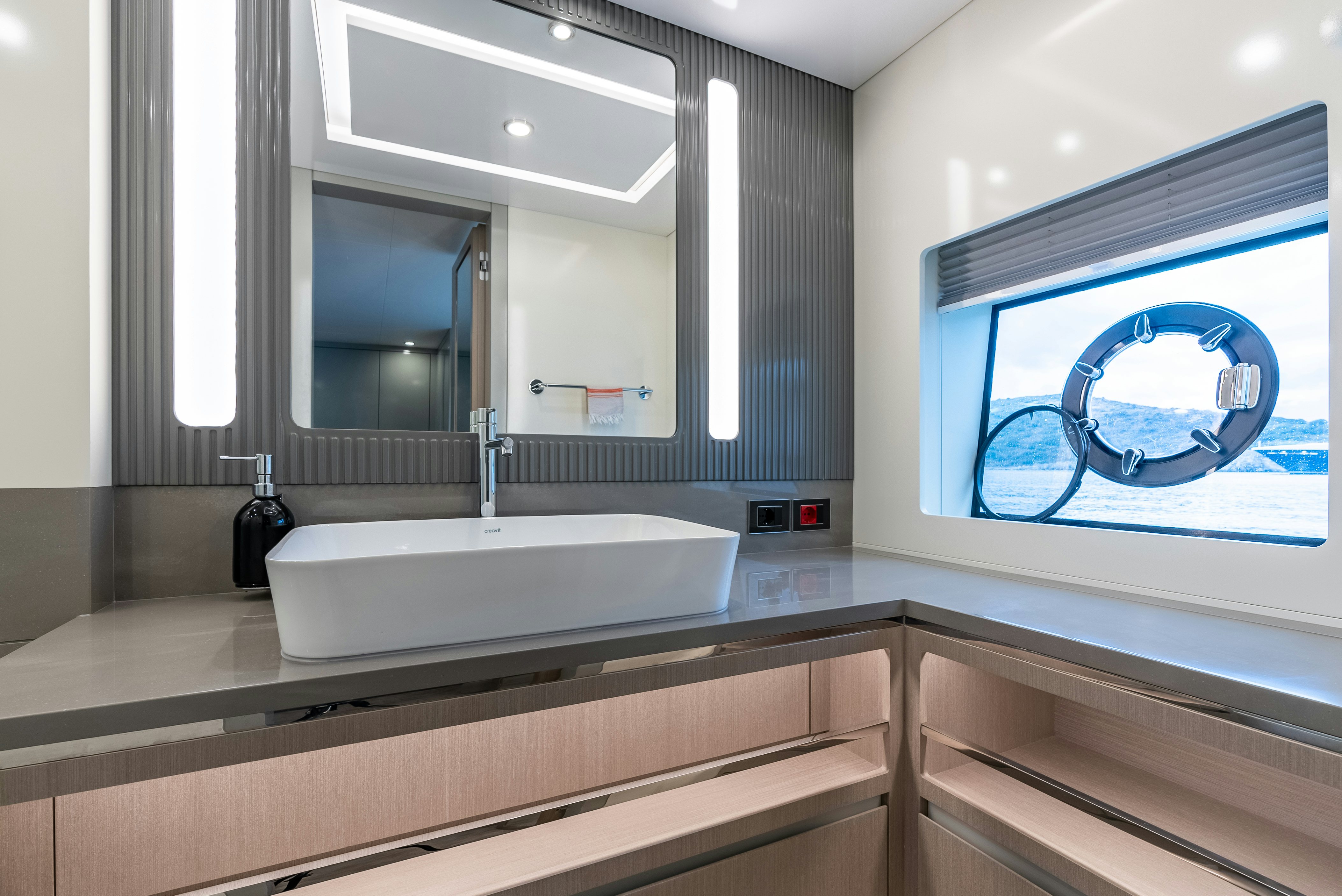 a bathroom with a large mirror aboard GALENE IV Yacht for Sale