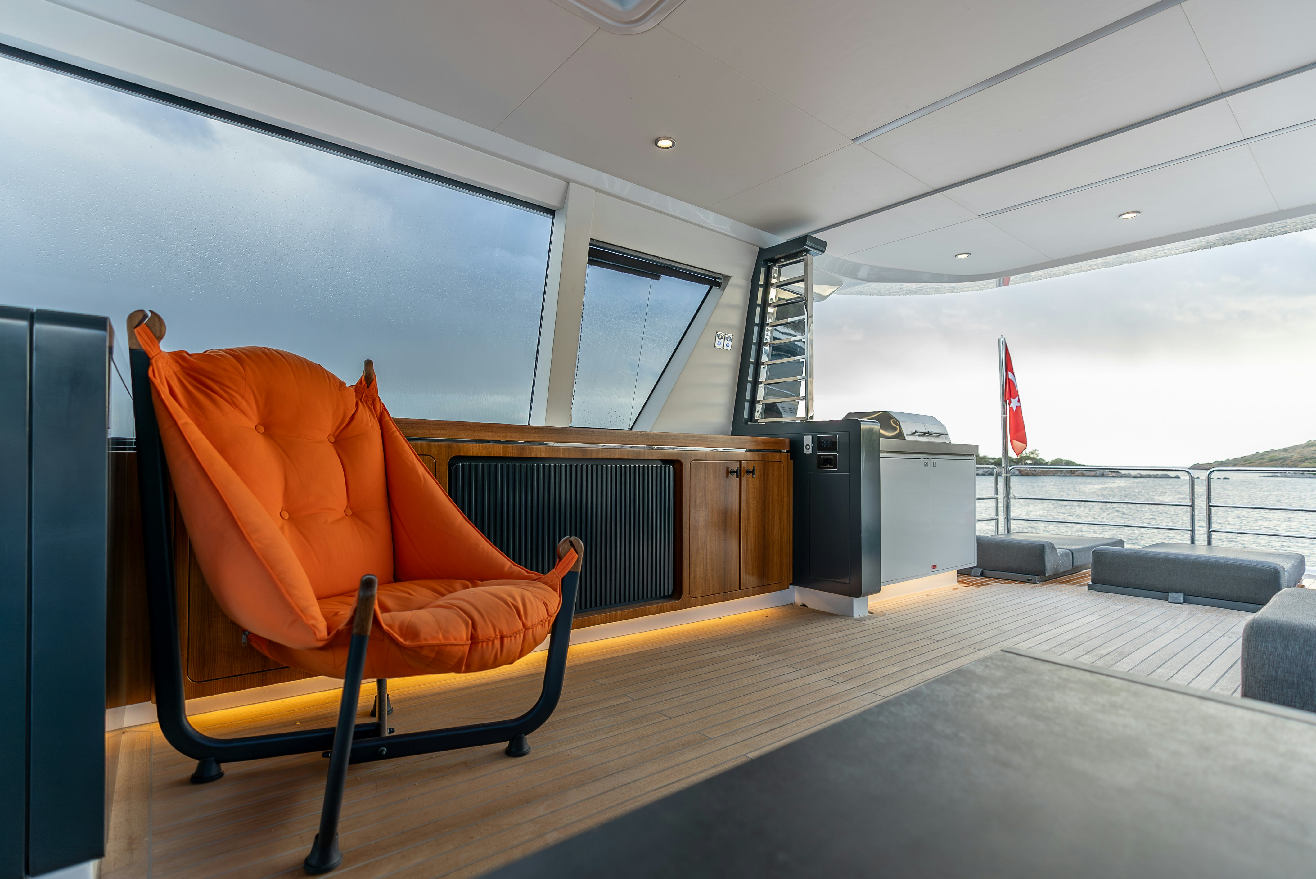 an orange chair in a room aboard GALENE IV Yacht for Sale