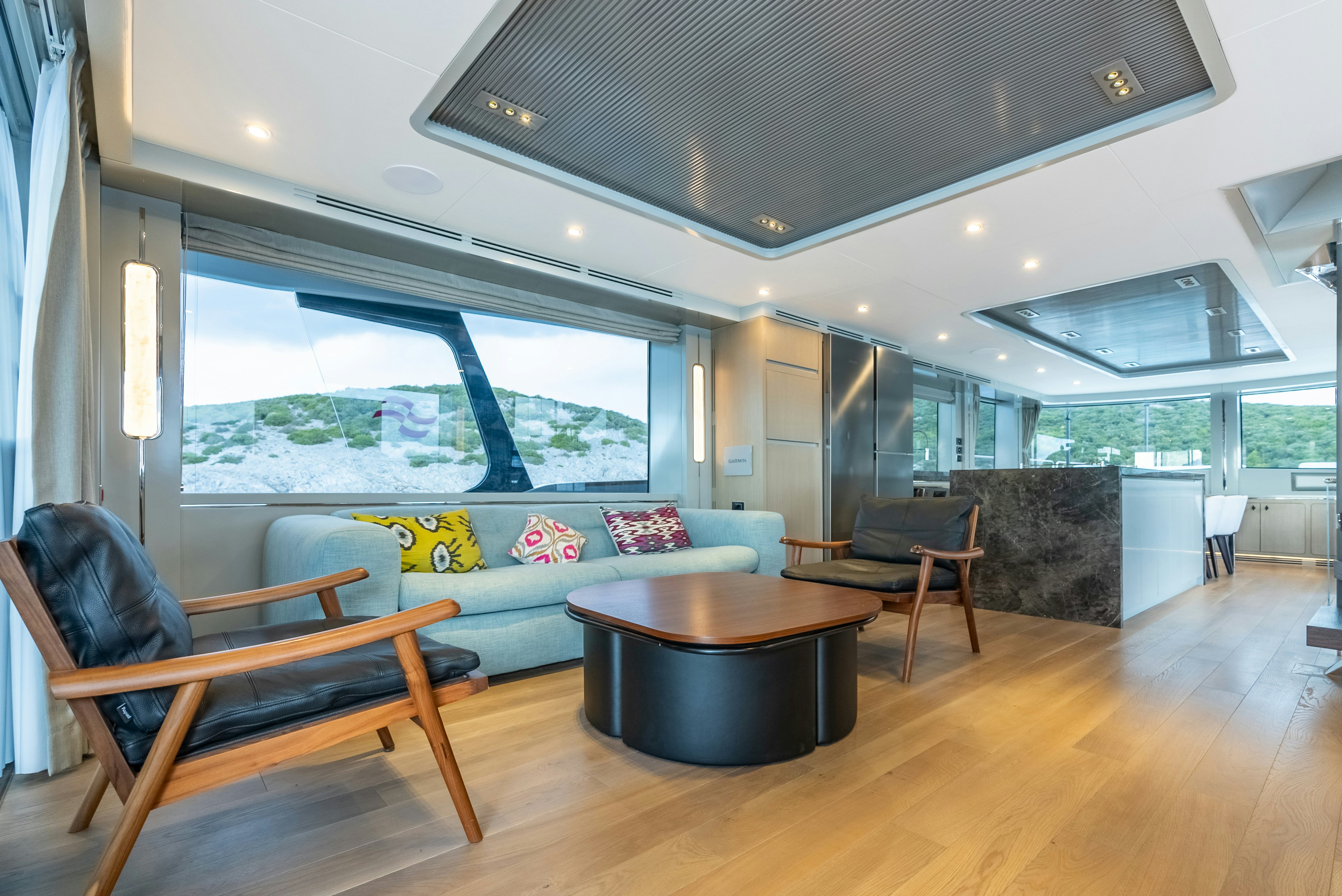 a living room with a large window aboard GALENE IV Yacht for Sale