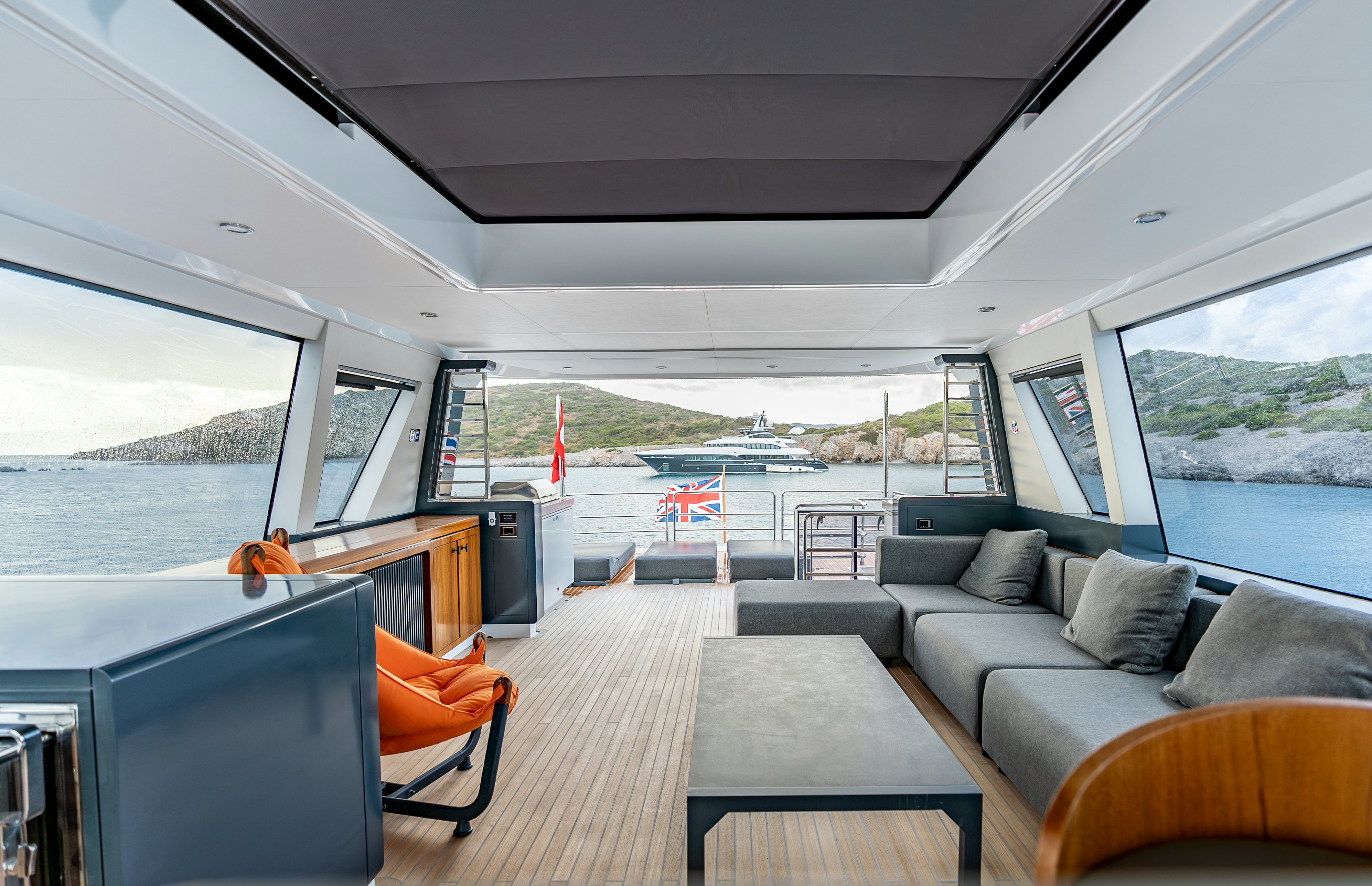 a large living room with a view of the ocean and the ocean aboard GALENE IV Yacht for Sale