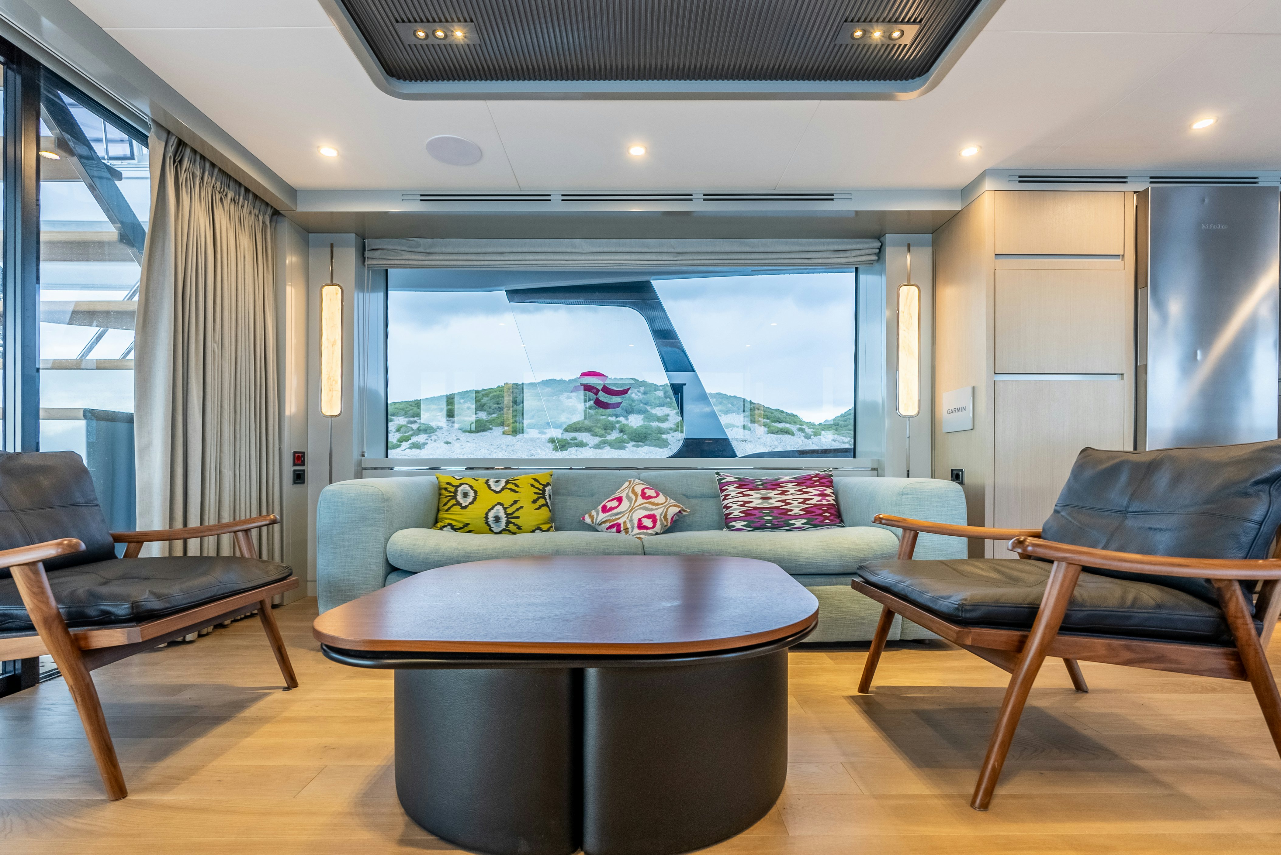 a living room with a table and chairs aboard GALENE IV Yacht for Sale