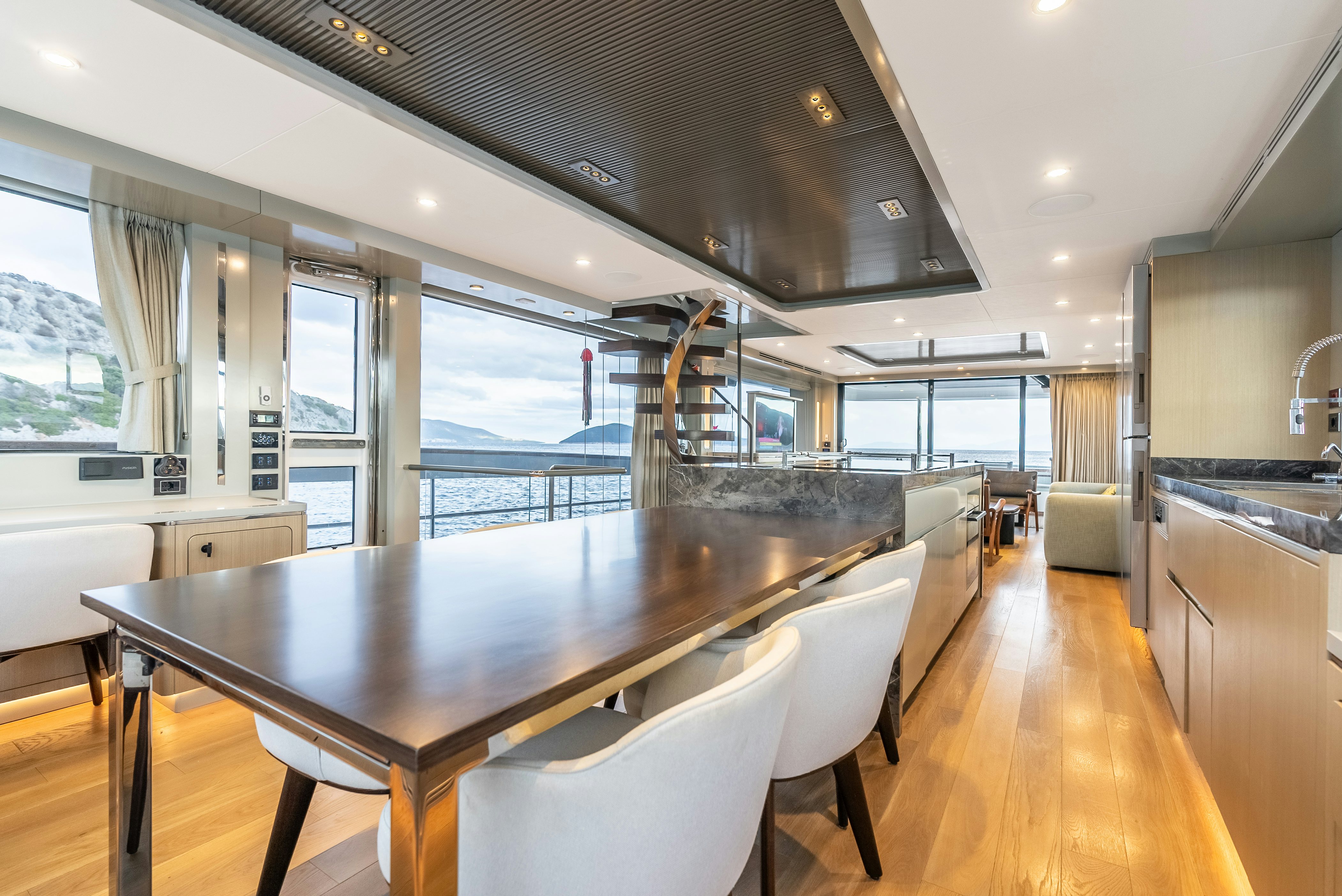 a large kitchen with a large dining table aboard GALENE IV Yacht for Sale