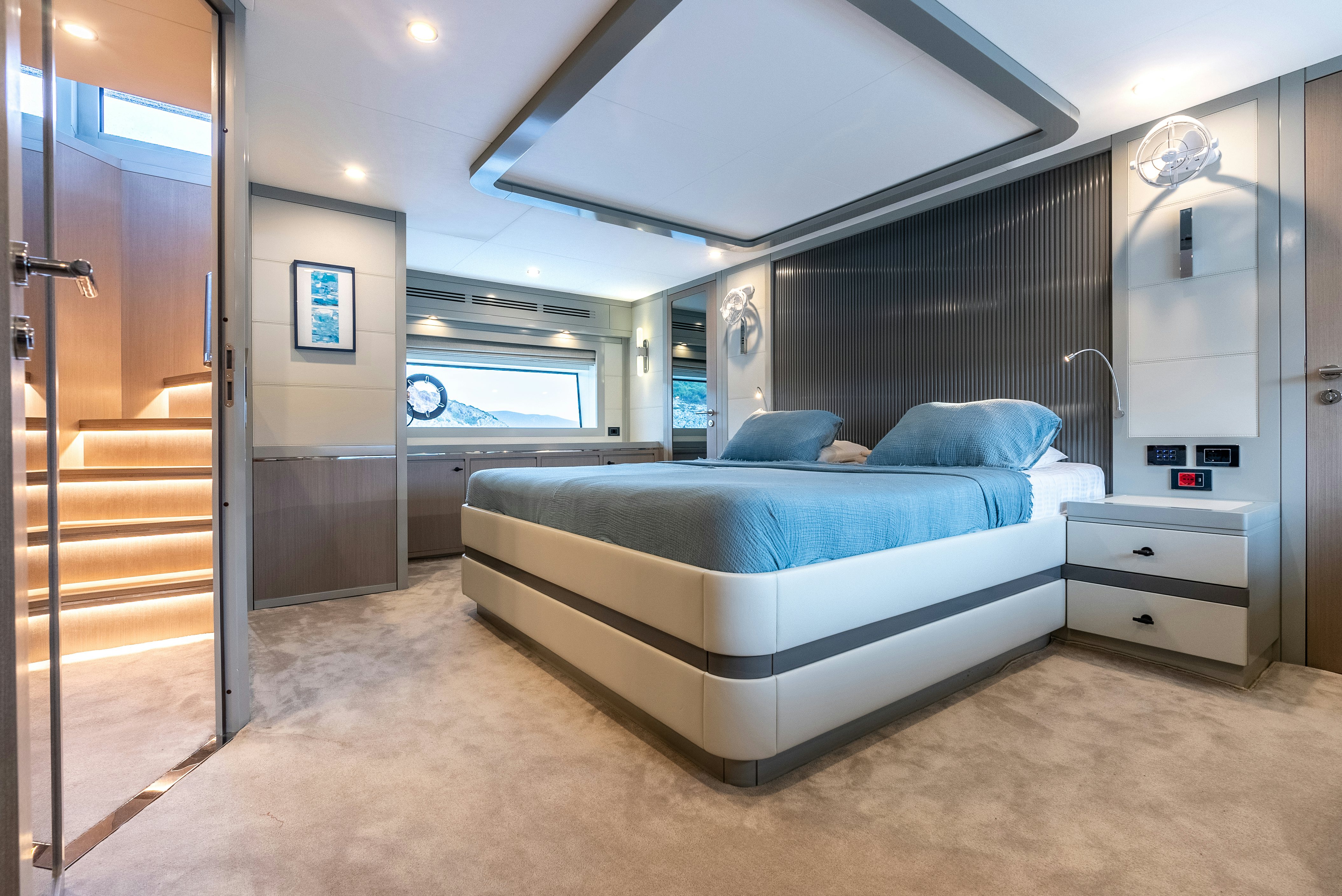 a bedroom with a bed and a door aboard GALENE IV Yacht for Sale