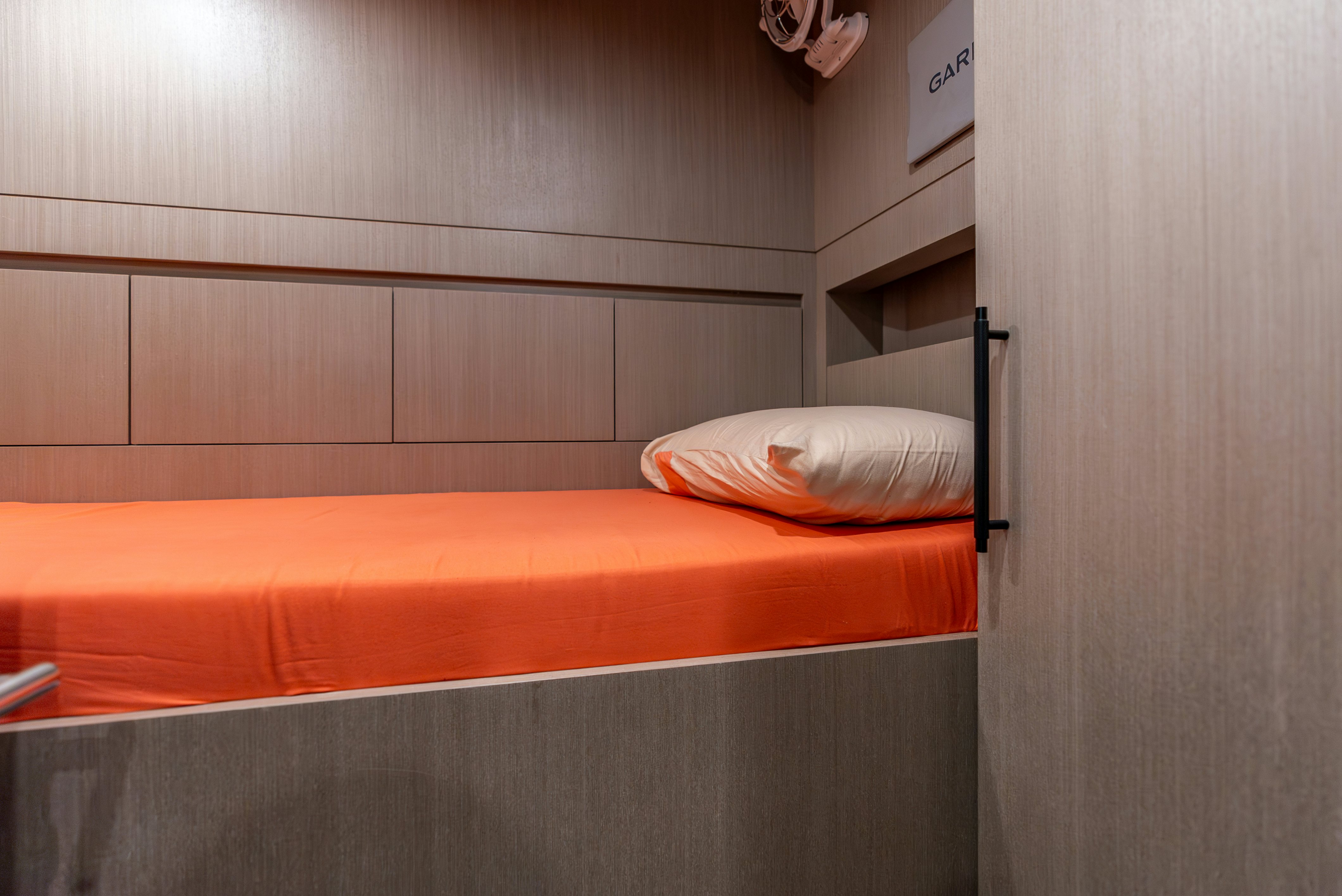 a bed with a wooden headboard aboard GALENE IV Yacht for Sale