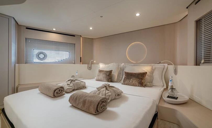 a bed with a white bed spread aboard SBK Yacht for Charter