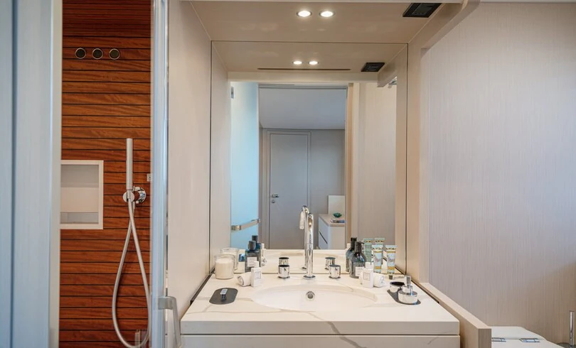 a bathroom with a sink and mirror aboard SBK Yacht for Charter