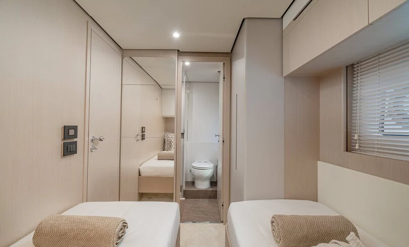 a bathroom with a bed and a closet aboard SBK Yacht for Charter