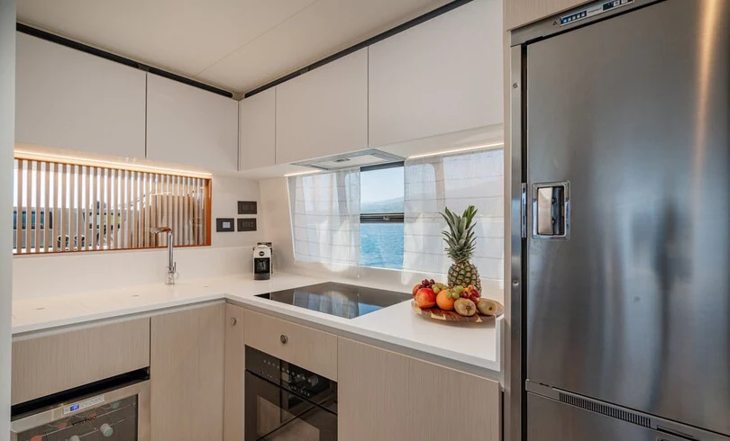 a kitchen with a large refrigerator aboard SBK Yacht for Charter