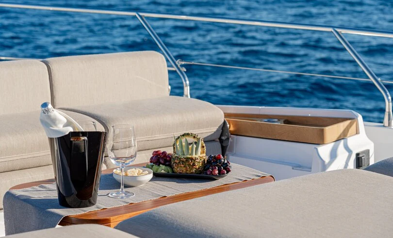 a table with a cup of coffee and a tray of food on it aboard SBK Yacht for Charter