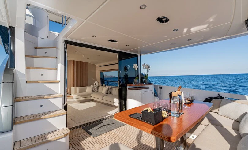 a modern looking living room with a large open door aboard SBK Yacht for Charter