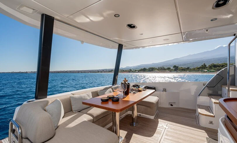 a boat with a table and chairs aboard SBK Yacht for Charter