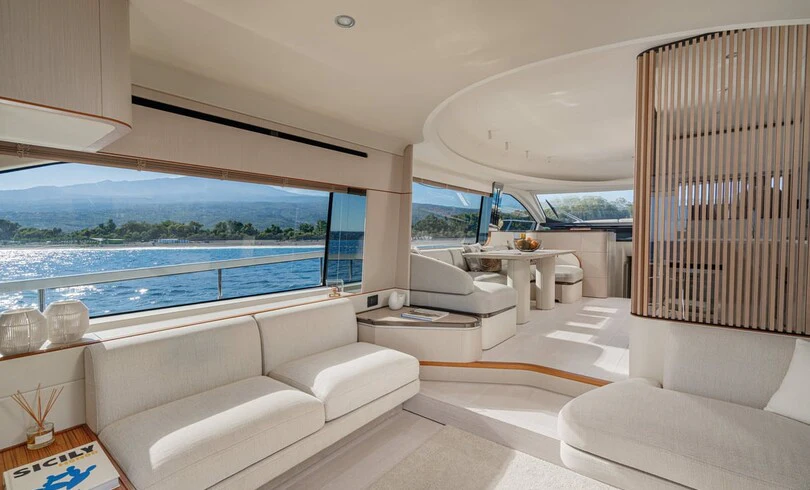a living room with a large window aboard SBK Yacht for Charter