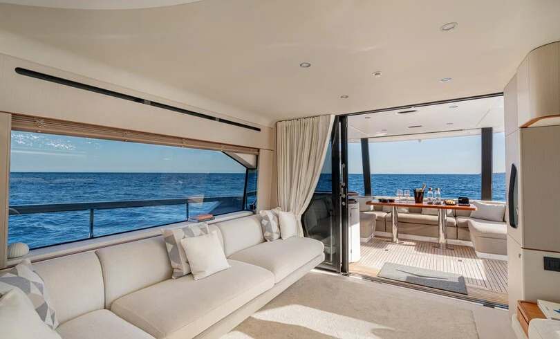 a living room with a large blue ocean aboard SBK Yacht for Charter