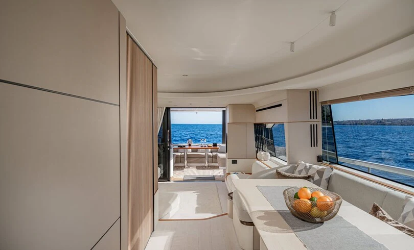 a room with a table and a view of the ocean aboard SBK Yacht for Charter