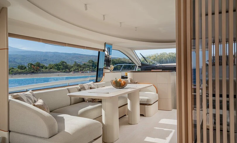 a room with a table and chairs aboard SBK Yacht for Charter