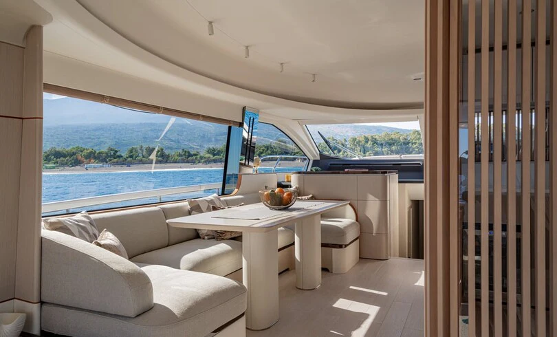 a room with a table and a couch aboard SBK Yacht for Charter