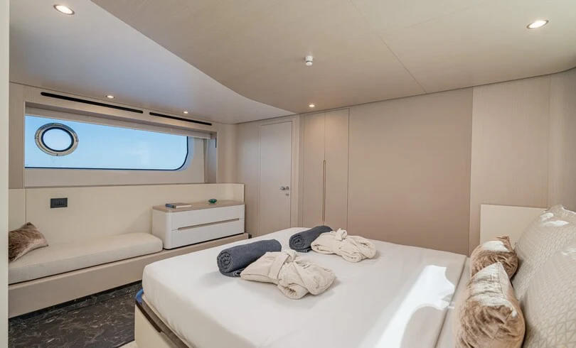 a bedroom with a bed and a large mirror aboard SBK Yacht for Charter