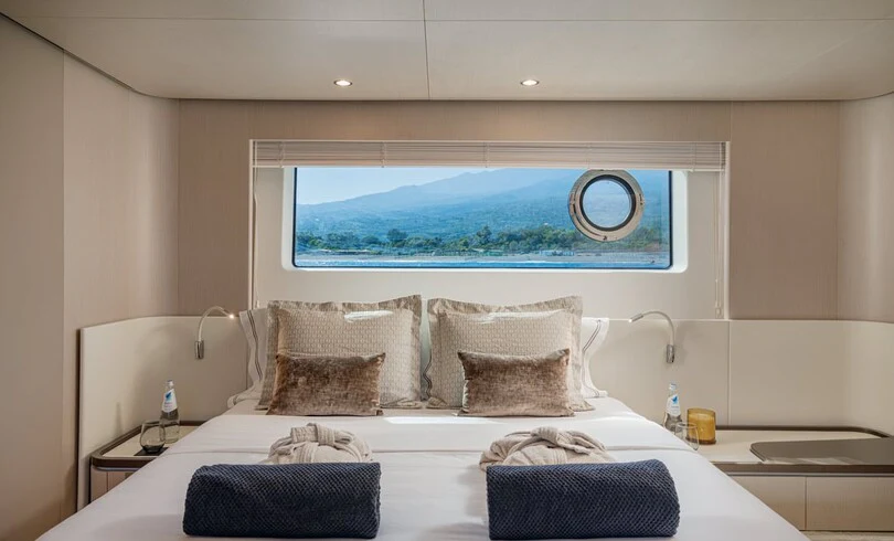 a bed with a large mirror above it aboard SBK Yacht for Charter