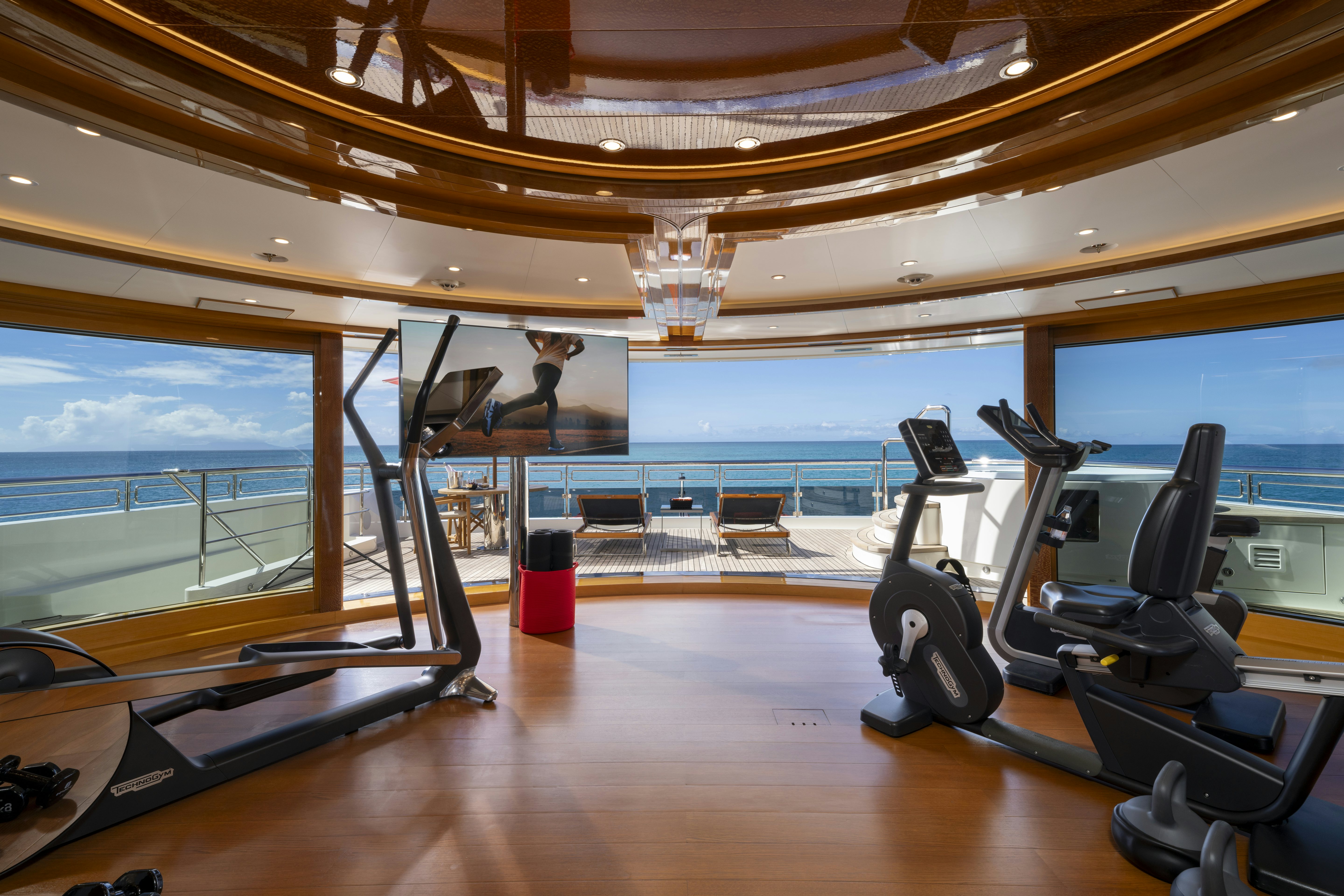 gym with a large window aboard ALFA NERO Yacht for Charter