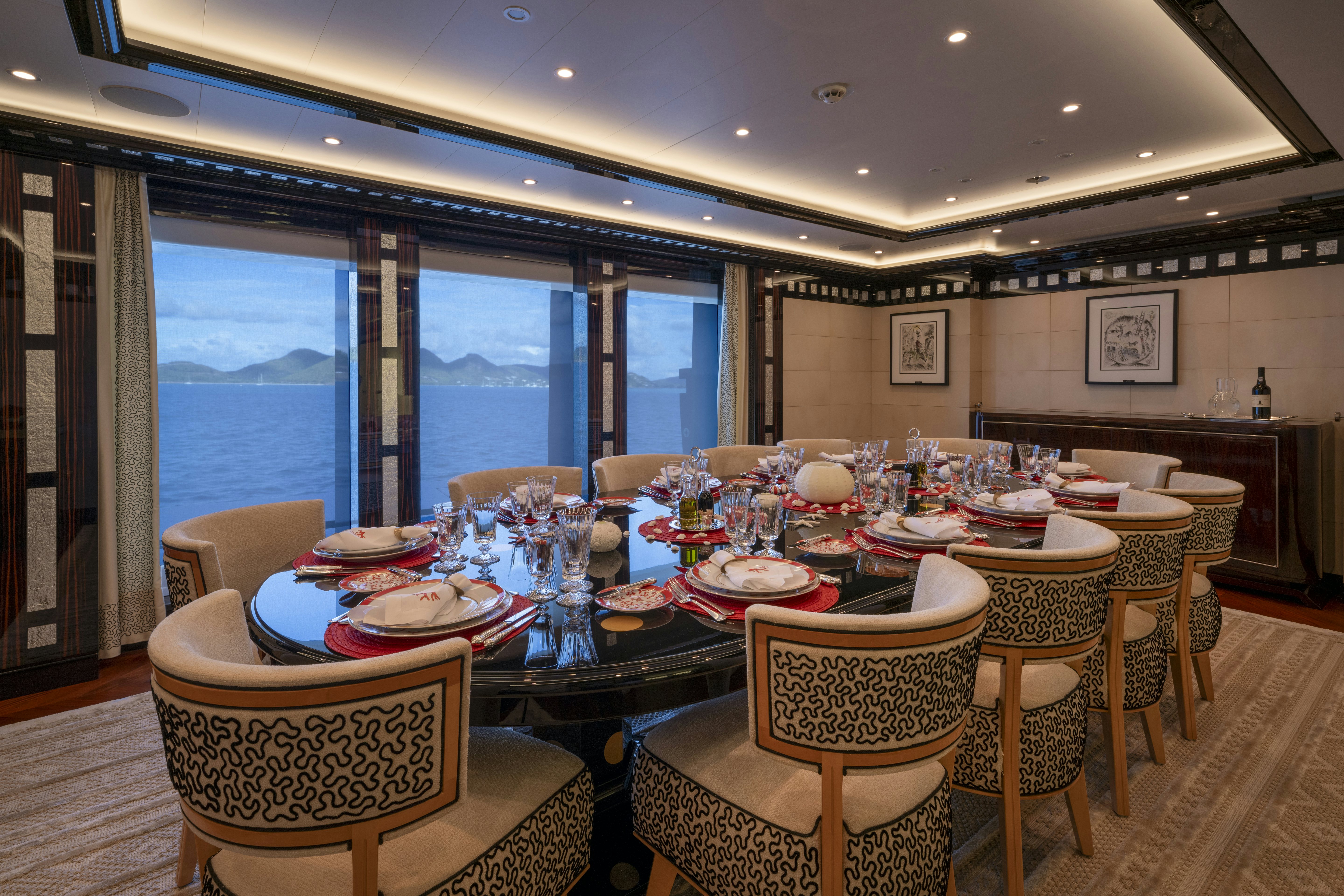 a dining room with a large window aboard ALFA NERO Yacht for Charter