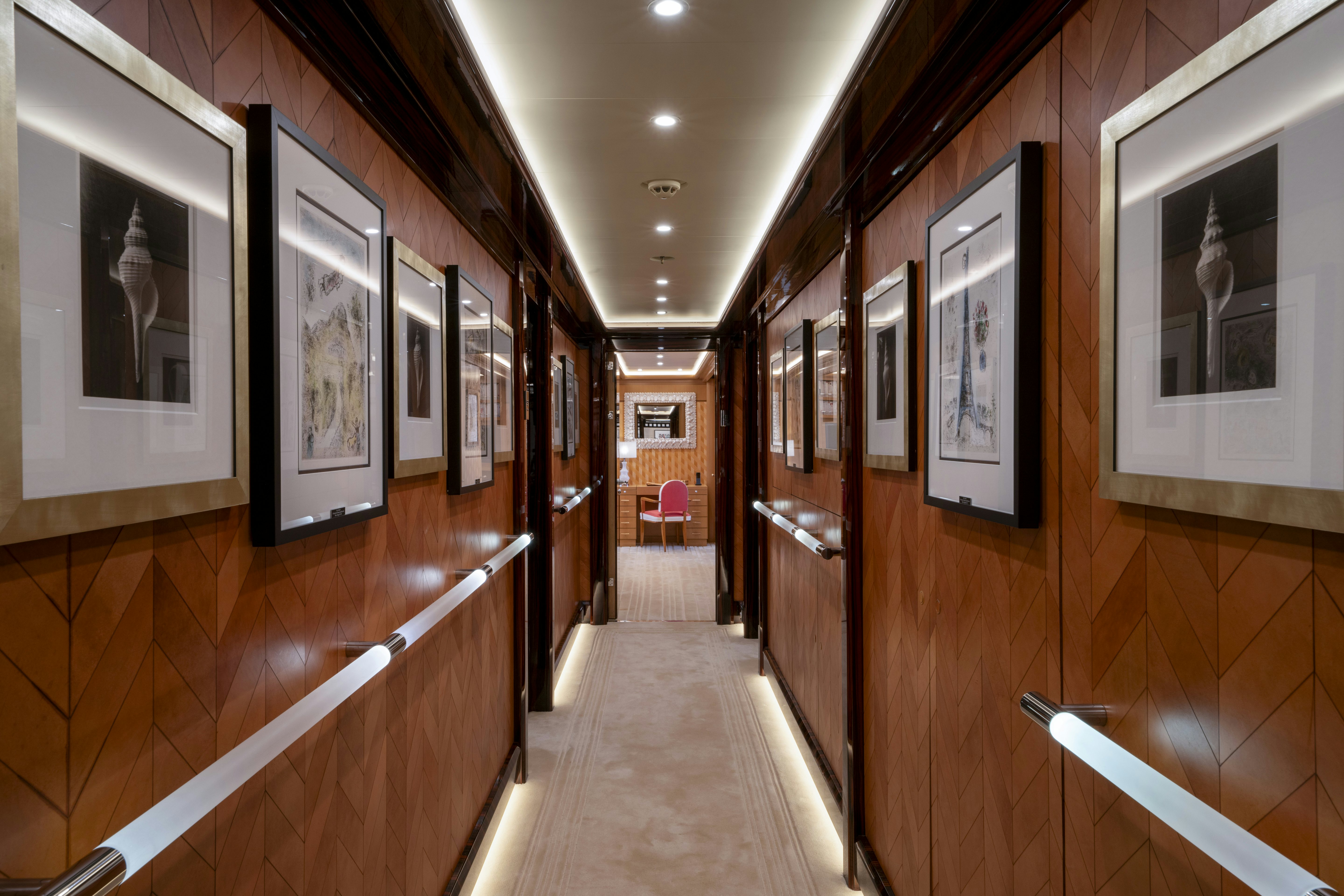 a hallway with framed paintings aboard ALFA NERO Yacht for Charter