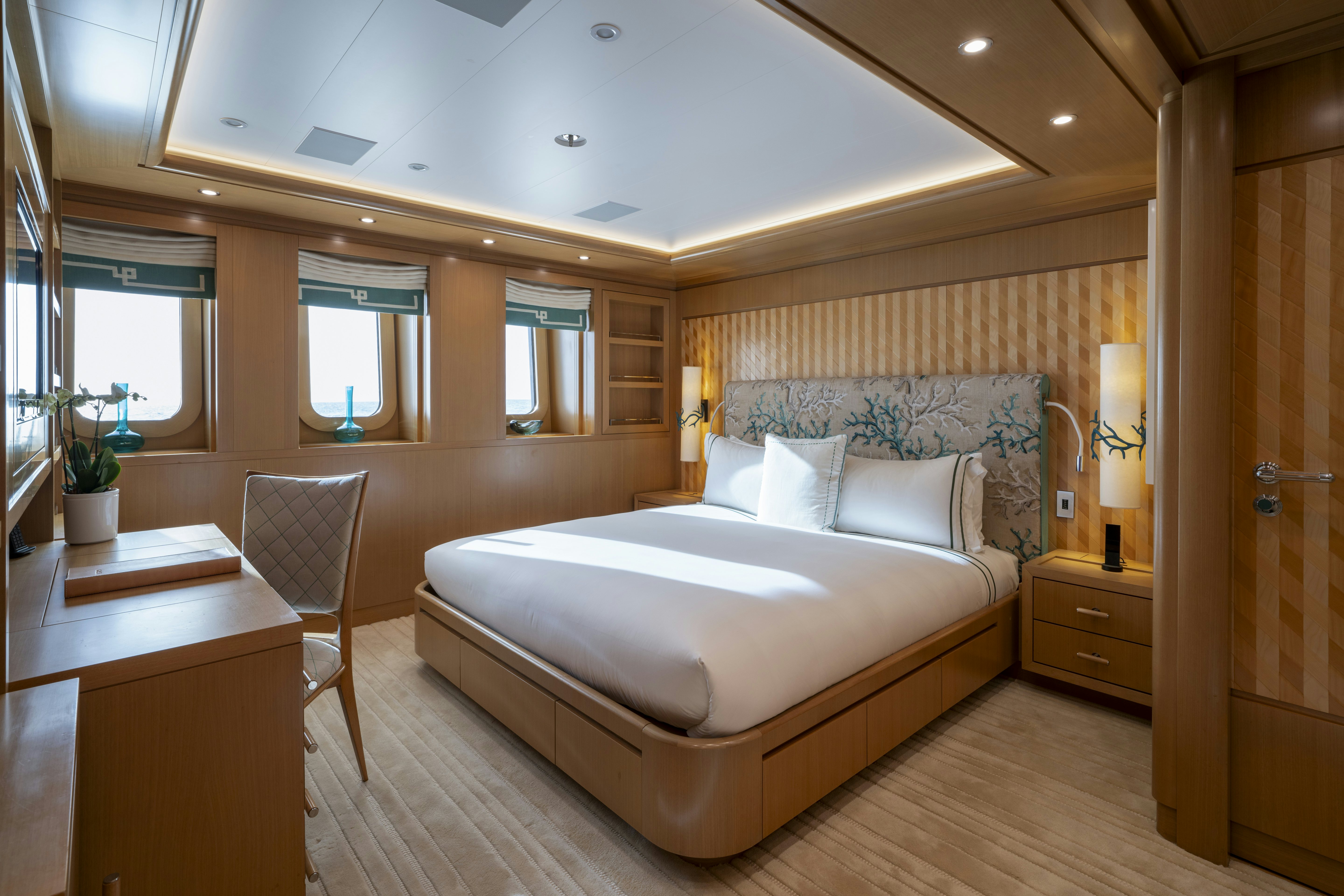 a bedroom with a bed and desk aboard ALFA NERO Yacht for Charter