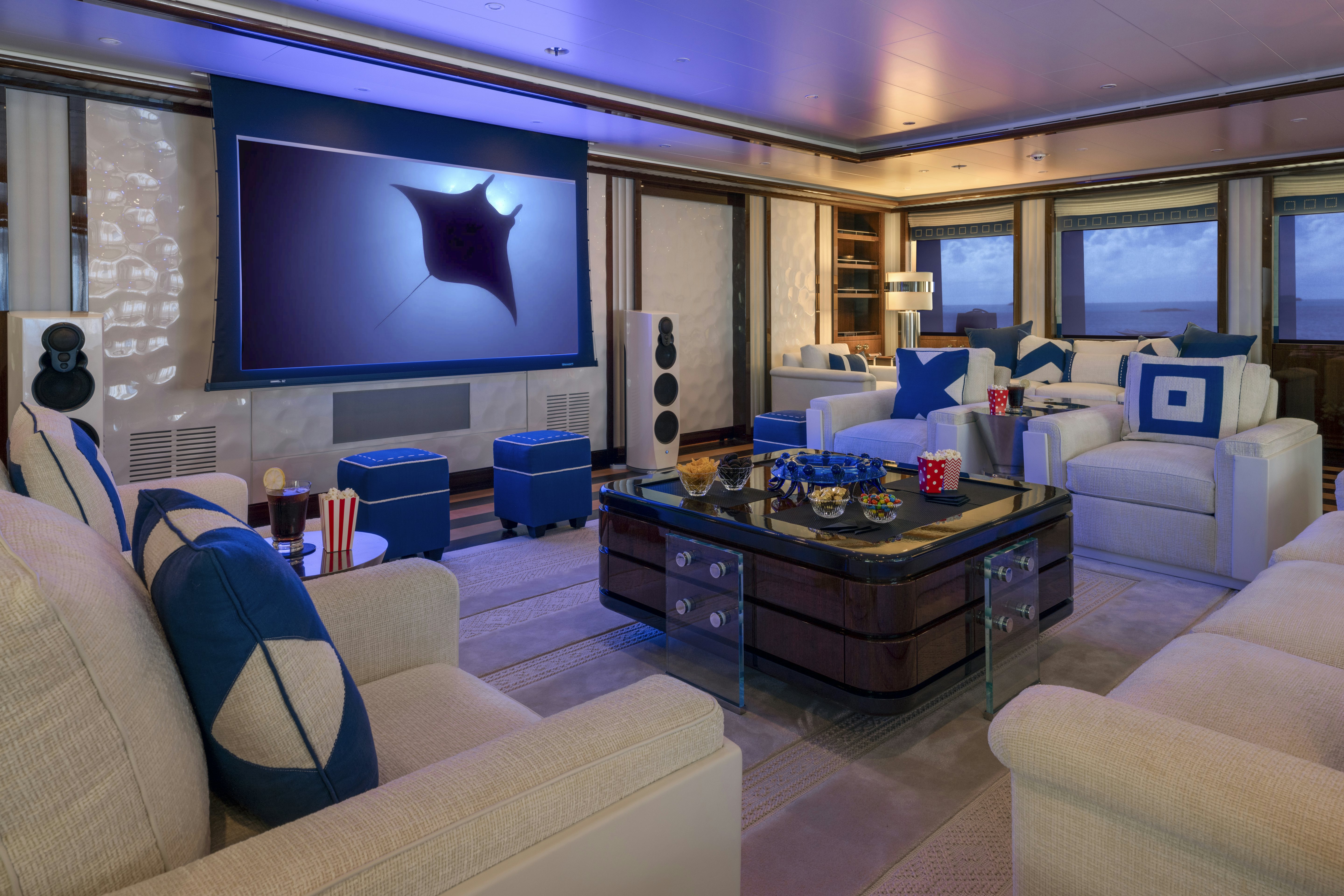 a living room with a tv and a table aboard ALFA NERO Yacht for Charter