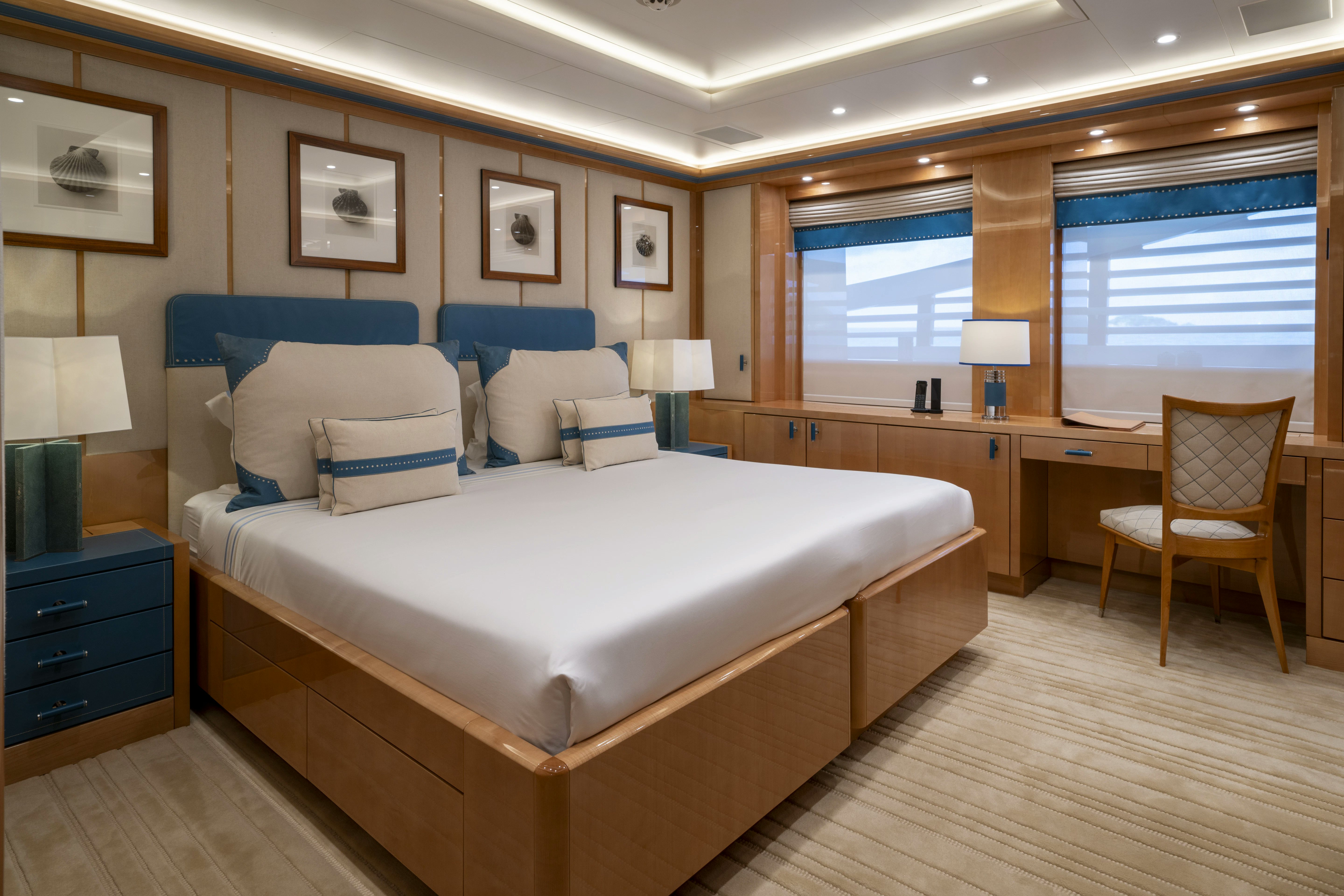 a bedroom with a bed and desk aboard ALFA NERO Yacht for Sale