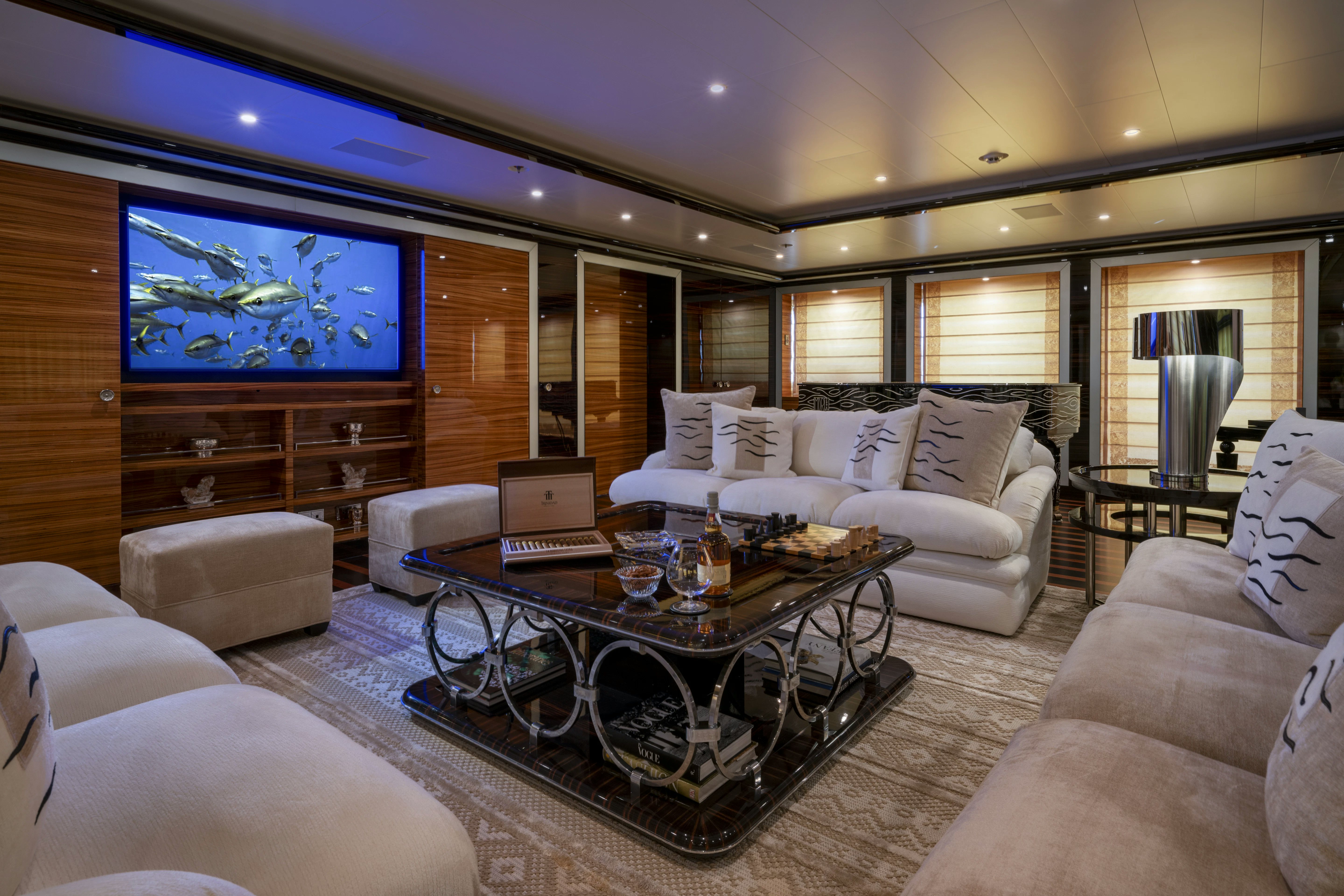 a living room with a large screen aboard ALFA NERO Yacht for Sale