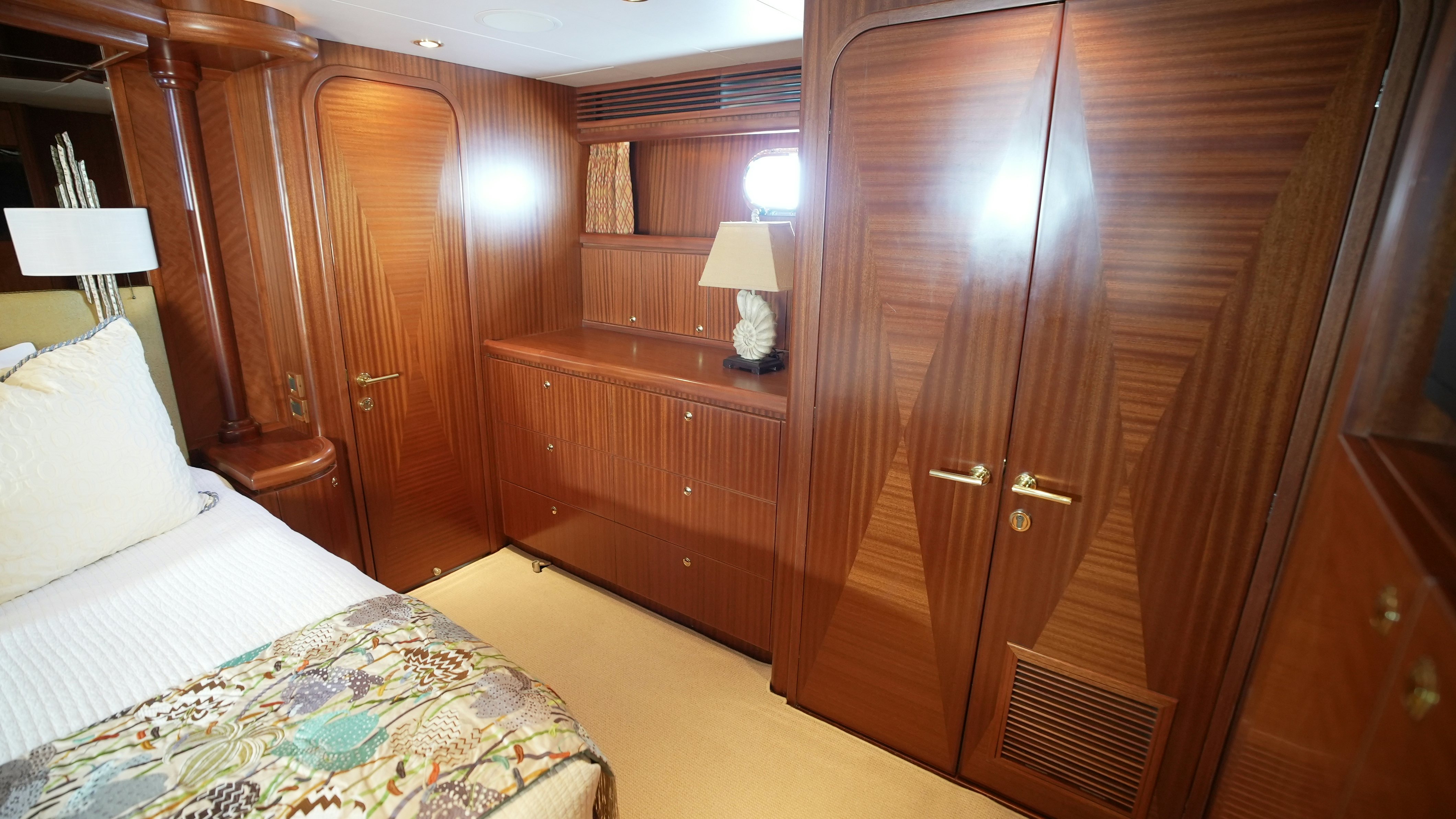 a room with a bed and a wood cabinet aboard SEA 2 SEA Yacht for Sale