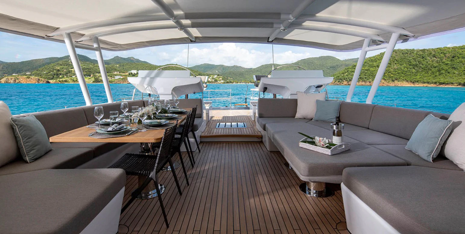 a deck with a table and chairs aboard RADIANCE Yacht for Charter