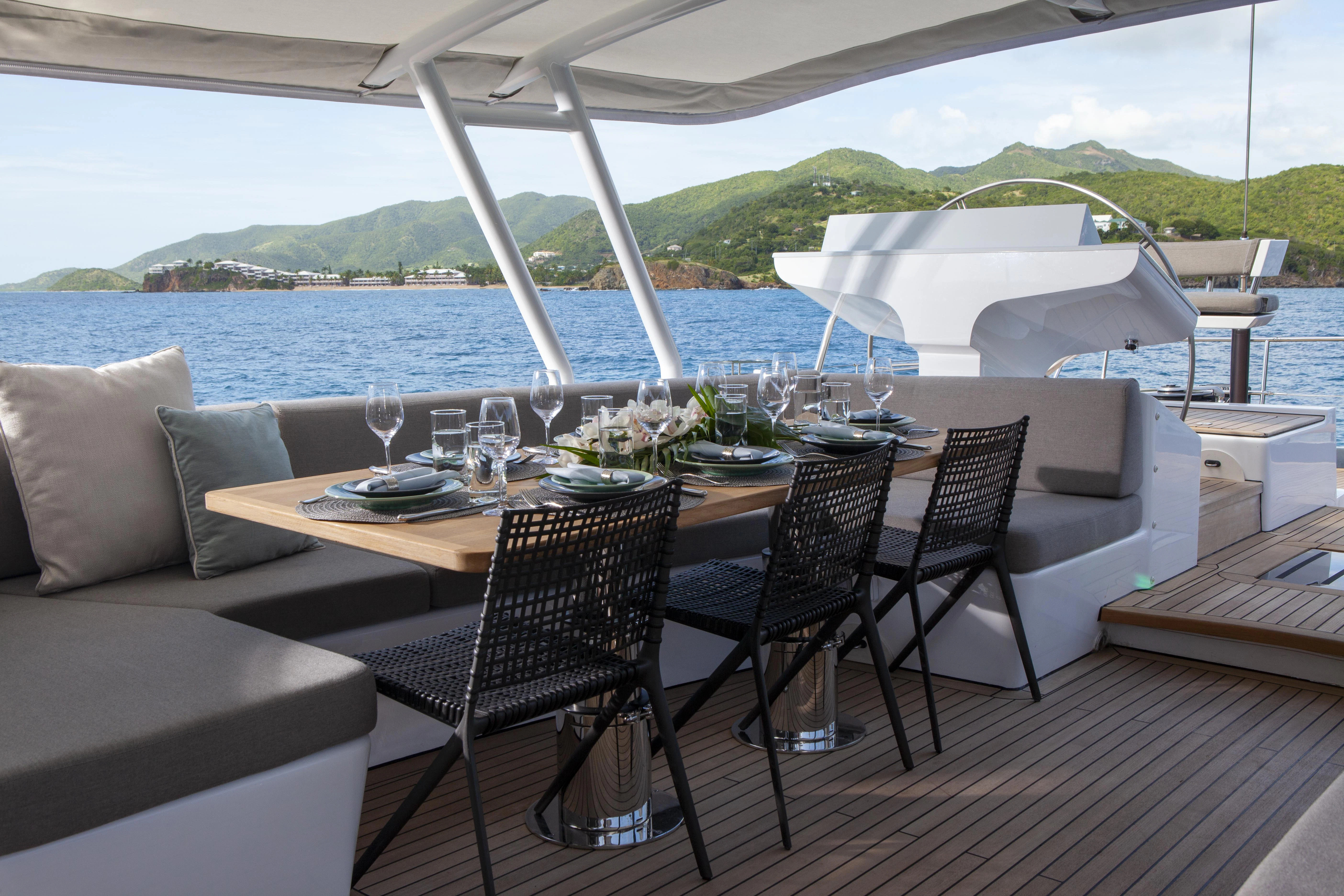 a table set for a meal on a deck aboard RADIANCE Yacht for Charter
