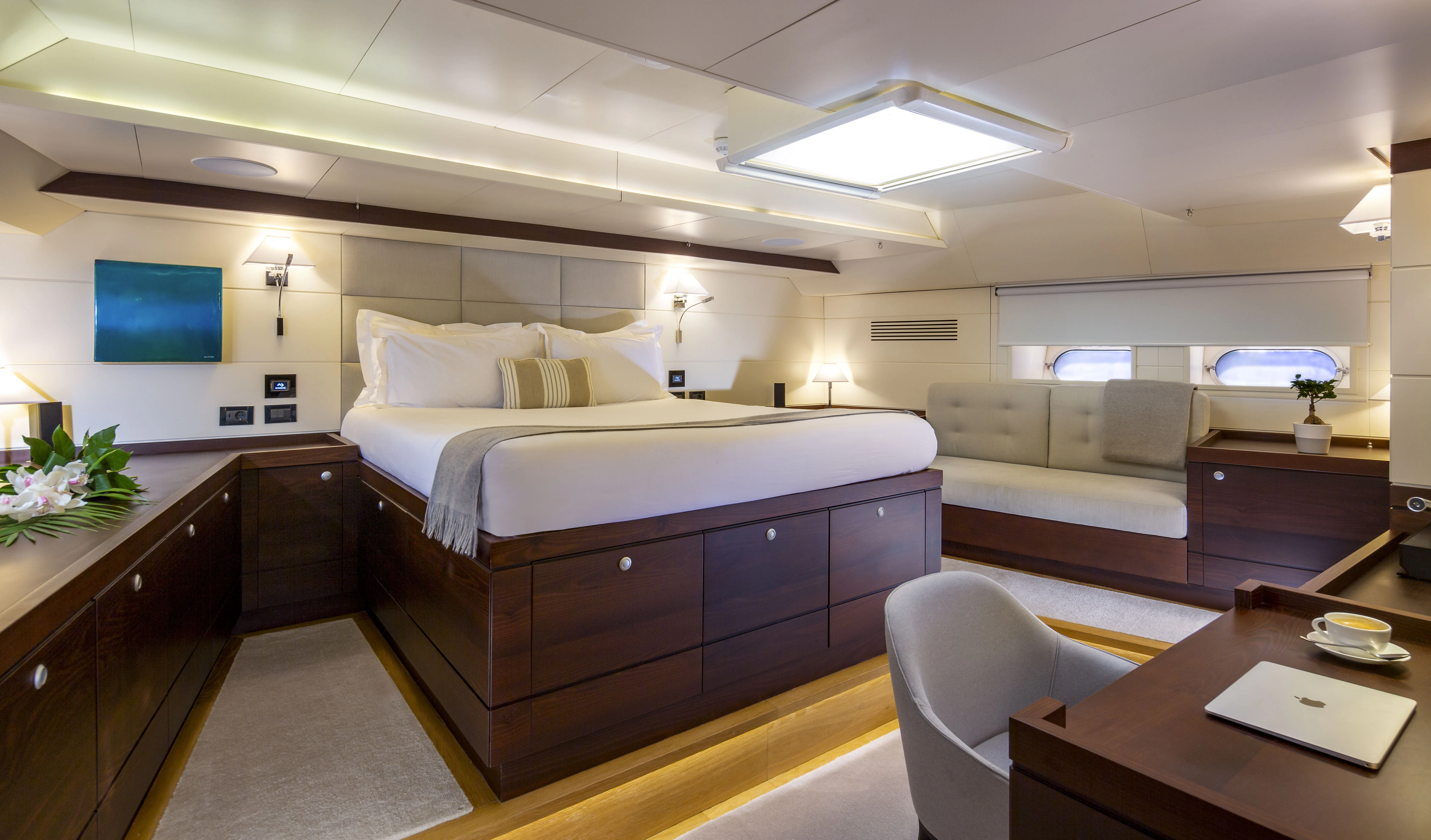 a bedroom with a bed and a desk aboard RADIANCE Yacht for Charter