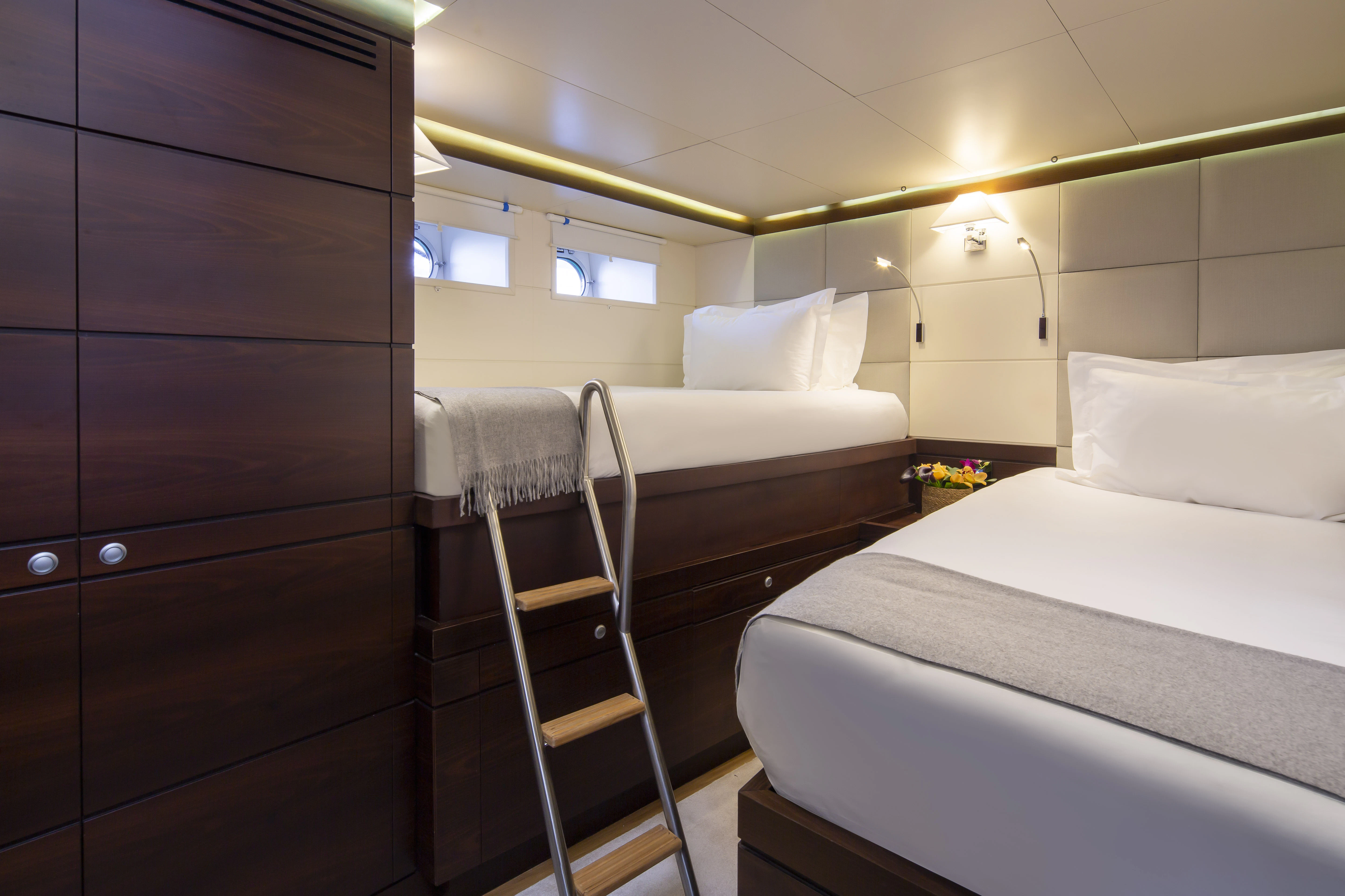 a room with a bunk bed and a ladder aboard RADIANCE Yacht for Charter