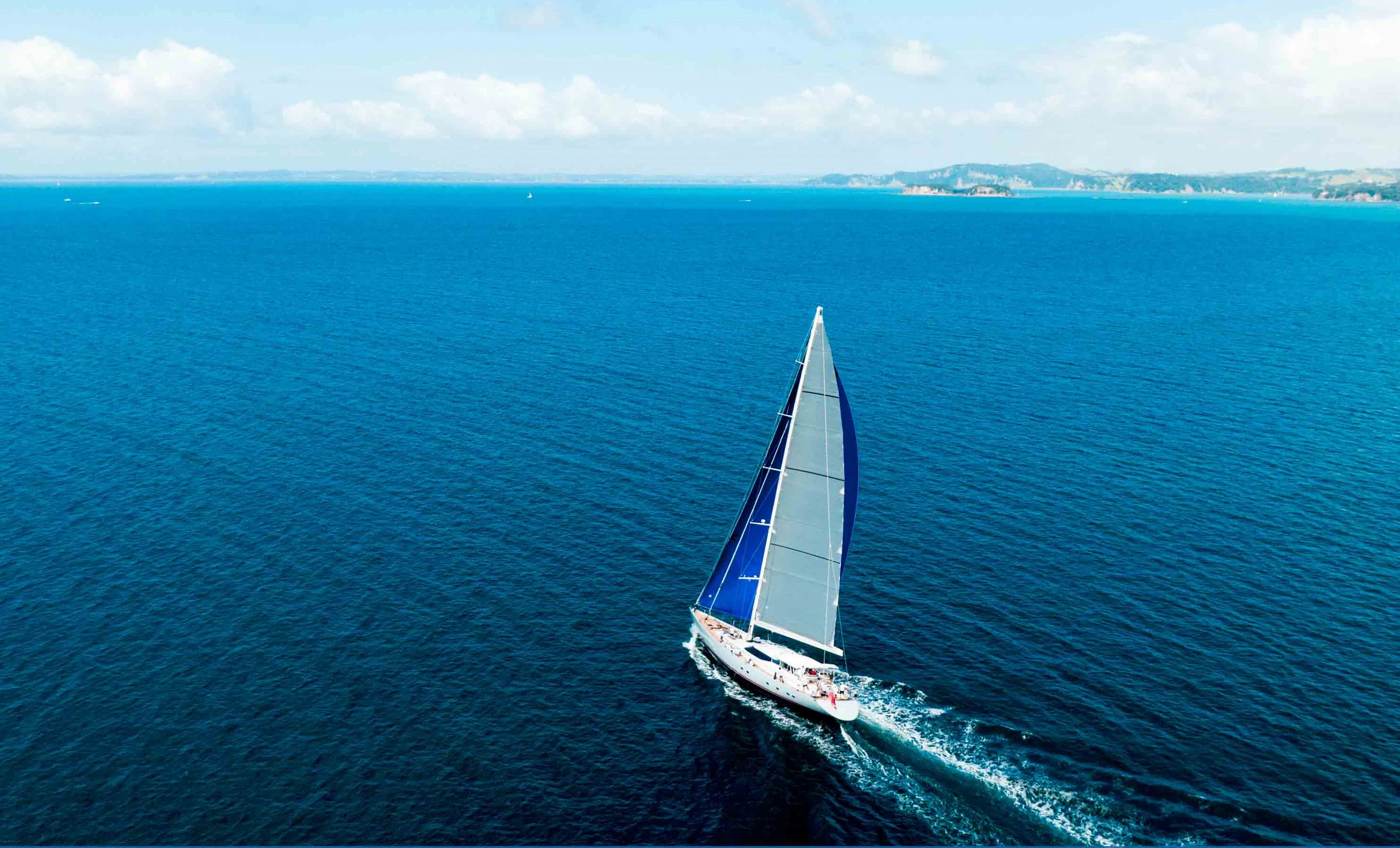 a boat sailing on the sea aboard RADIANCE Yacht for Charter