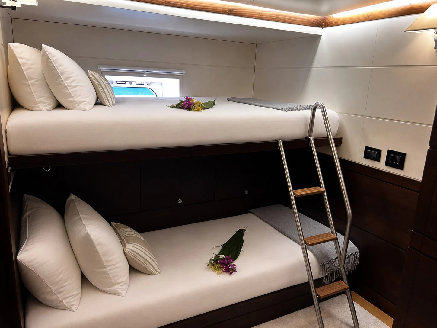 a bed with a white sheet and pillows on it aboard RADIANCE Yacht for Charter