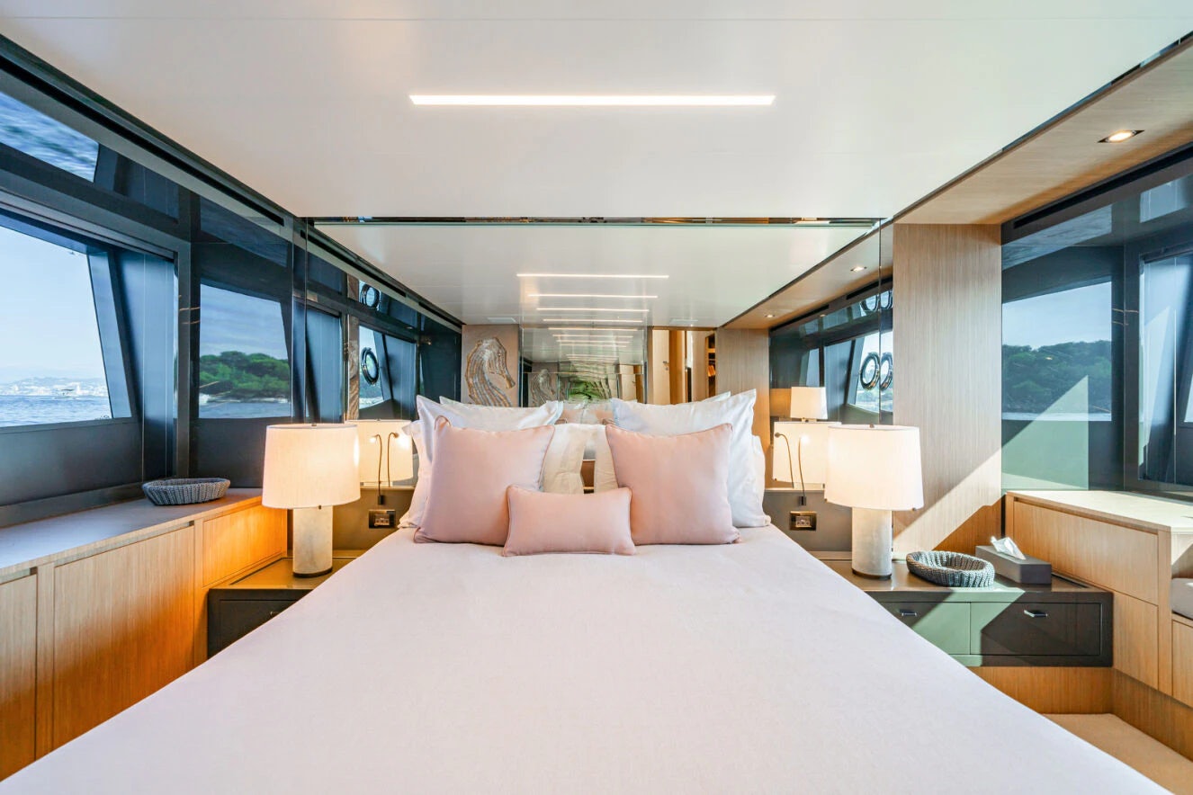 a bed with pillows and pillows aboard XANADU 76 Yacht for Sale